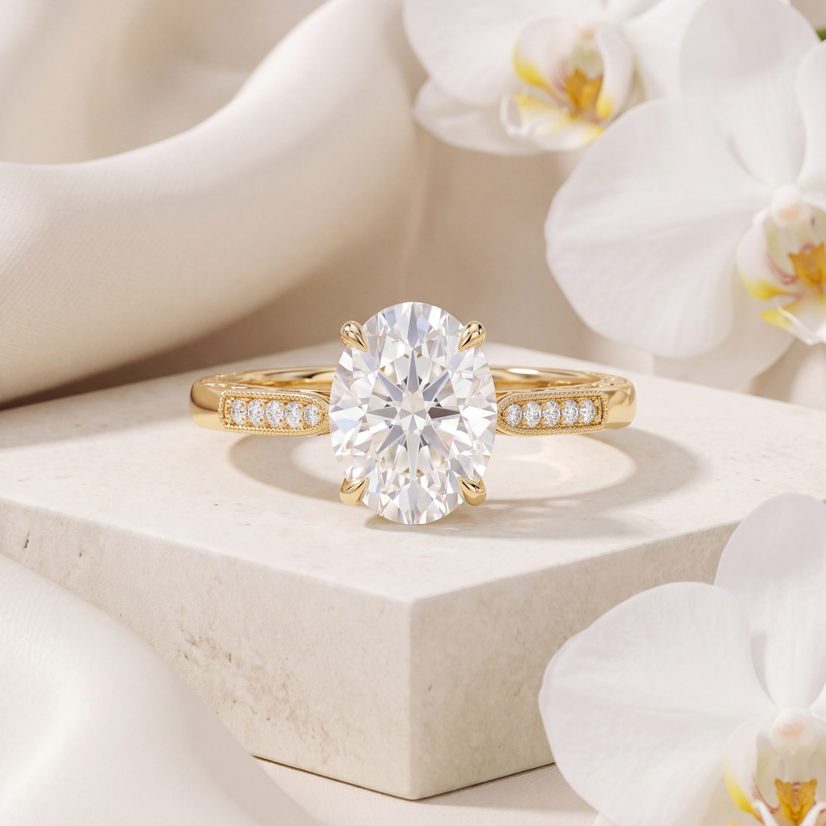 An oval-cut moissanite engagement ring set in a milgrain-accented yellow gold band.