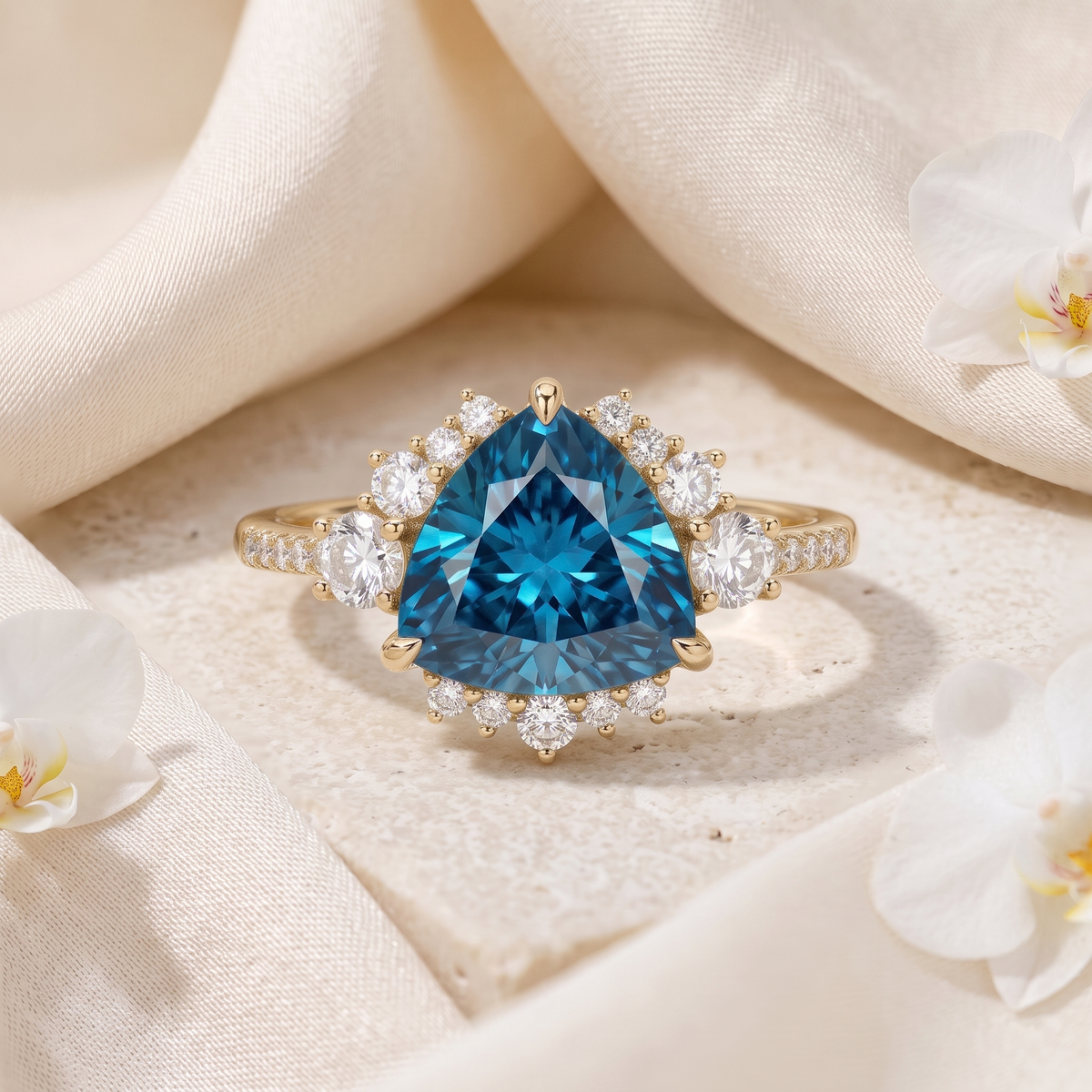 A yellow gold engagement ring featuring a trillion-cut blue moissanite center stone surrounded by a diamond cluster halo.