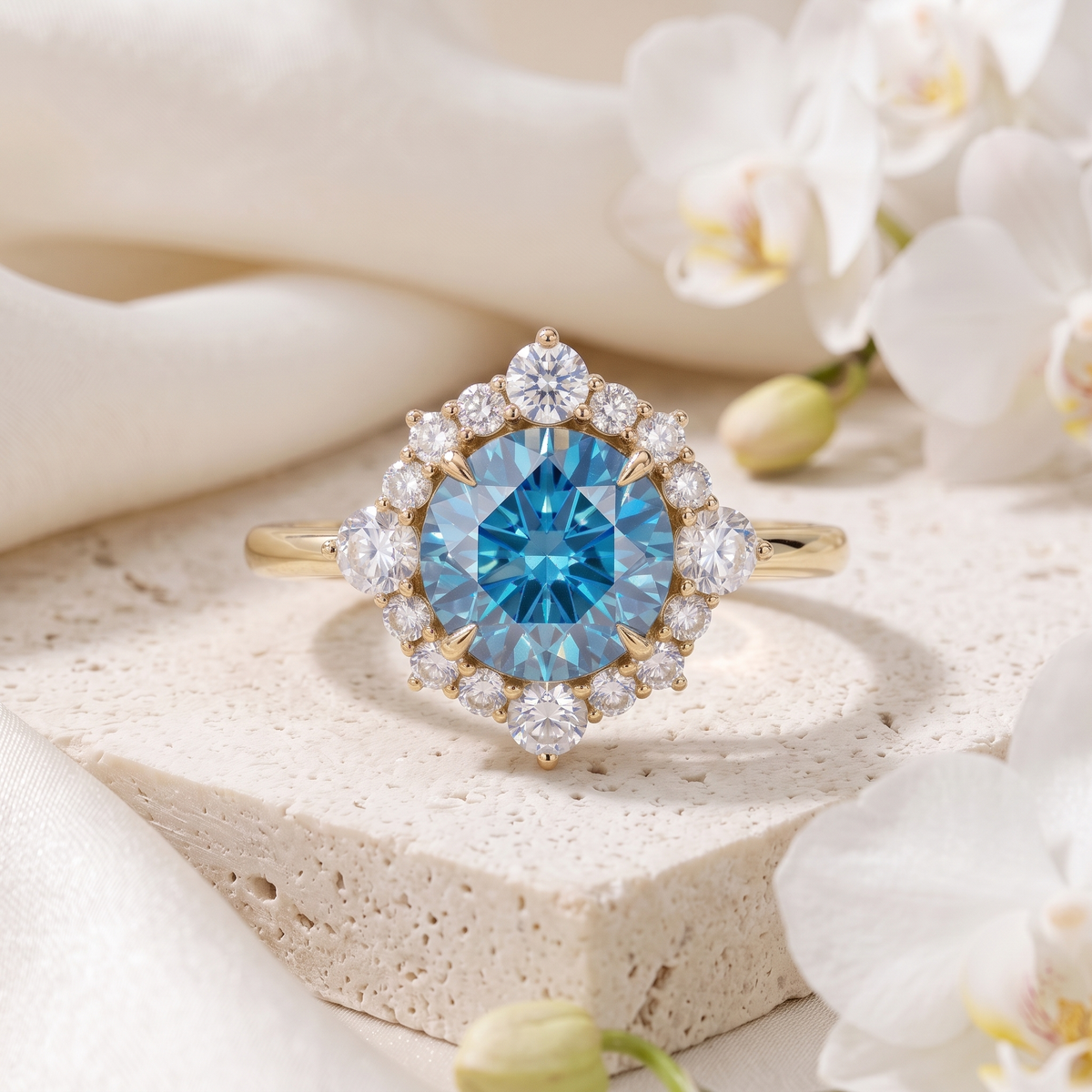Front view of a round blue moissanite halo engagement ring in yellow gold.