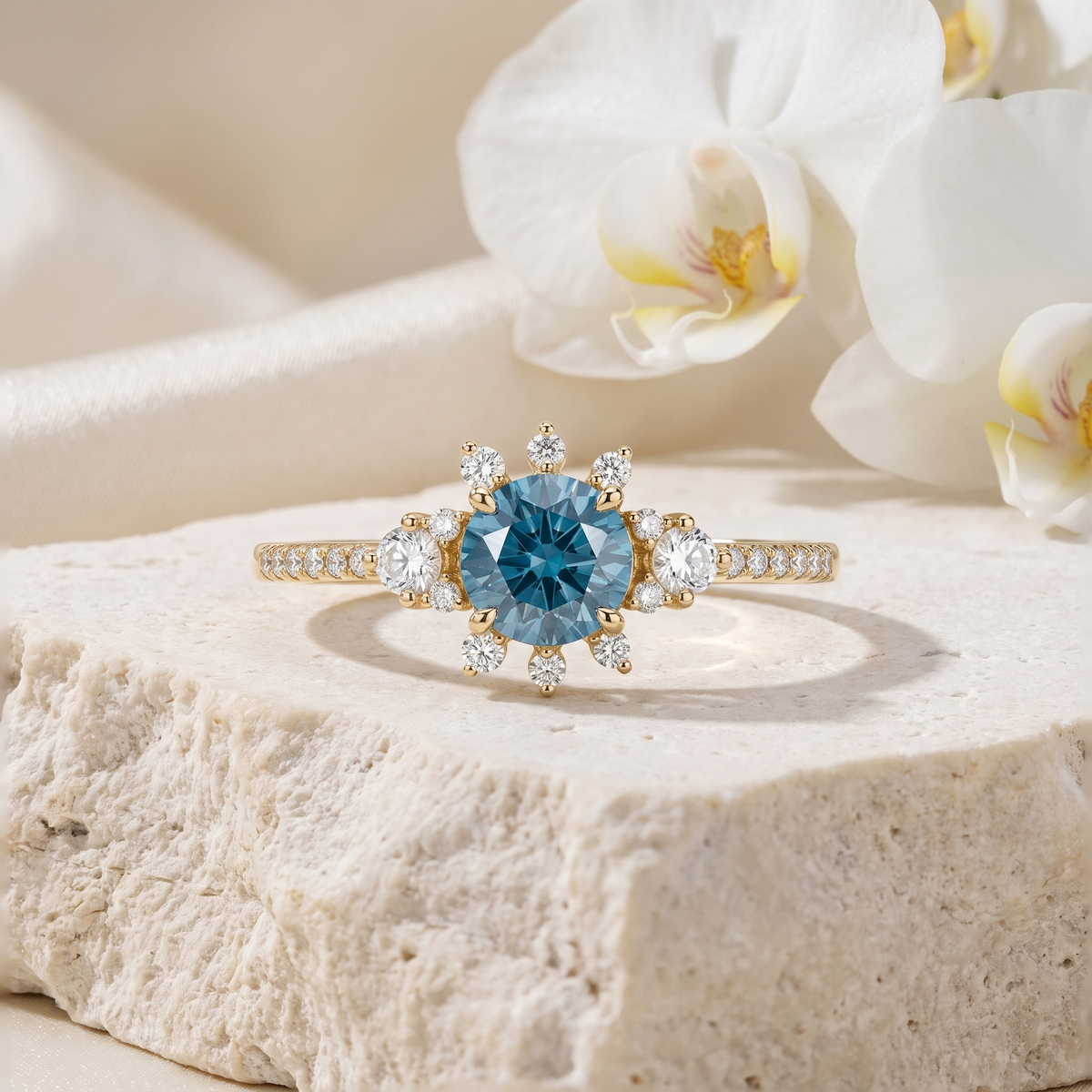 Yellow gold moissanite ring featuring a round blue center gemstone with a starburst halo setting.