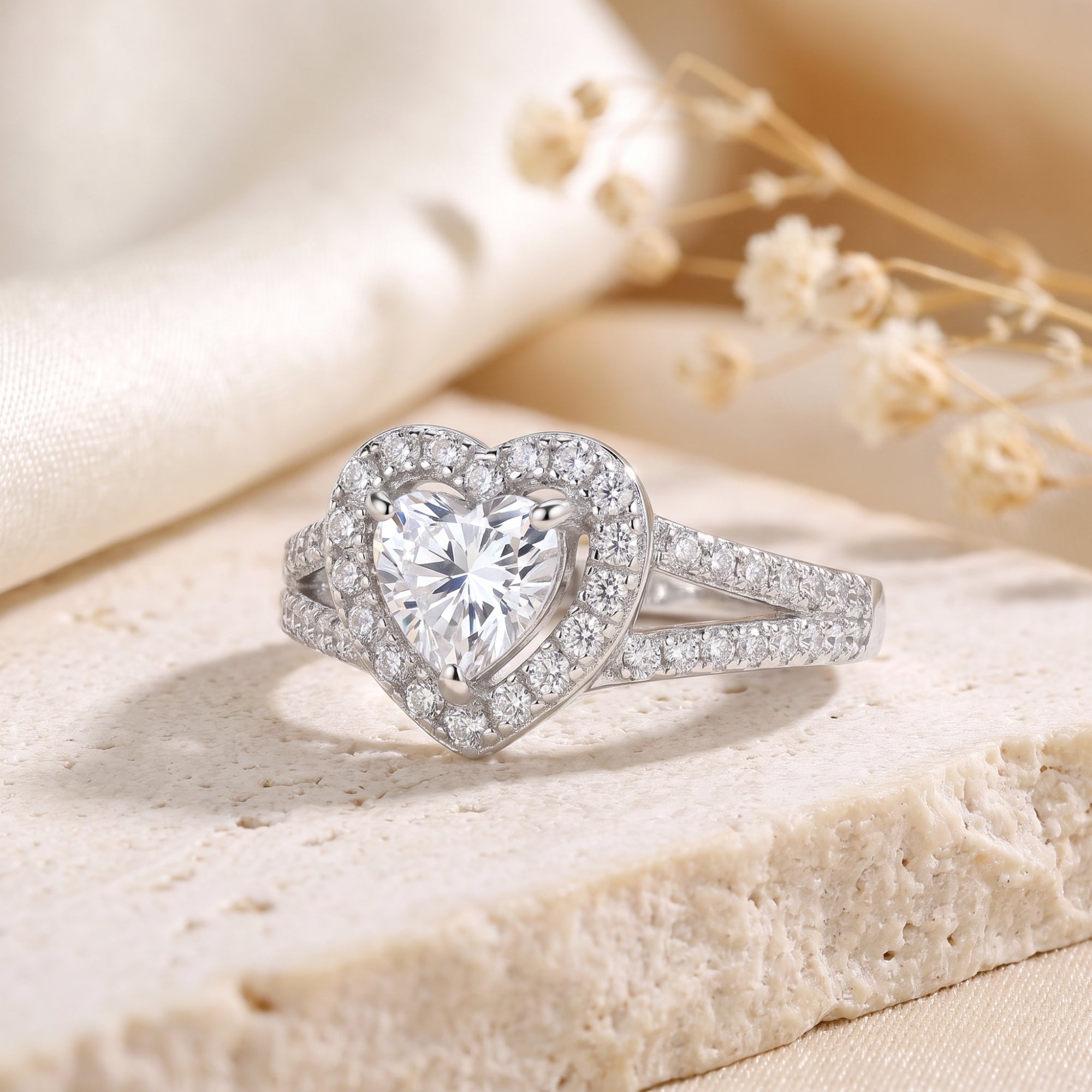 Heart-cut CZ halo promise ring in S925 sterling silver on a stone lifestyle background.