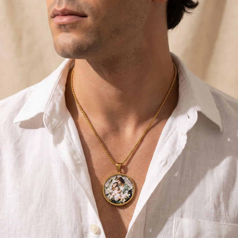 Male model wearing the gold-tone Holy Family medallion necklace over an open white shirt.