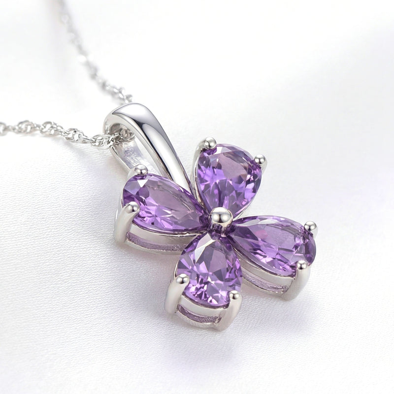 Close-up of the Amity clover pendant showing the S925 sterling silver setting and faceted purple simulated amethysts.