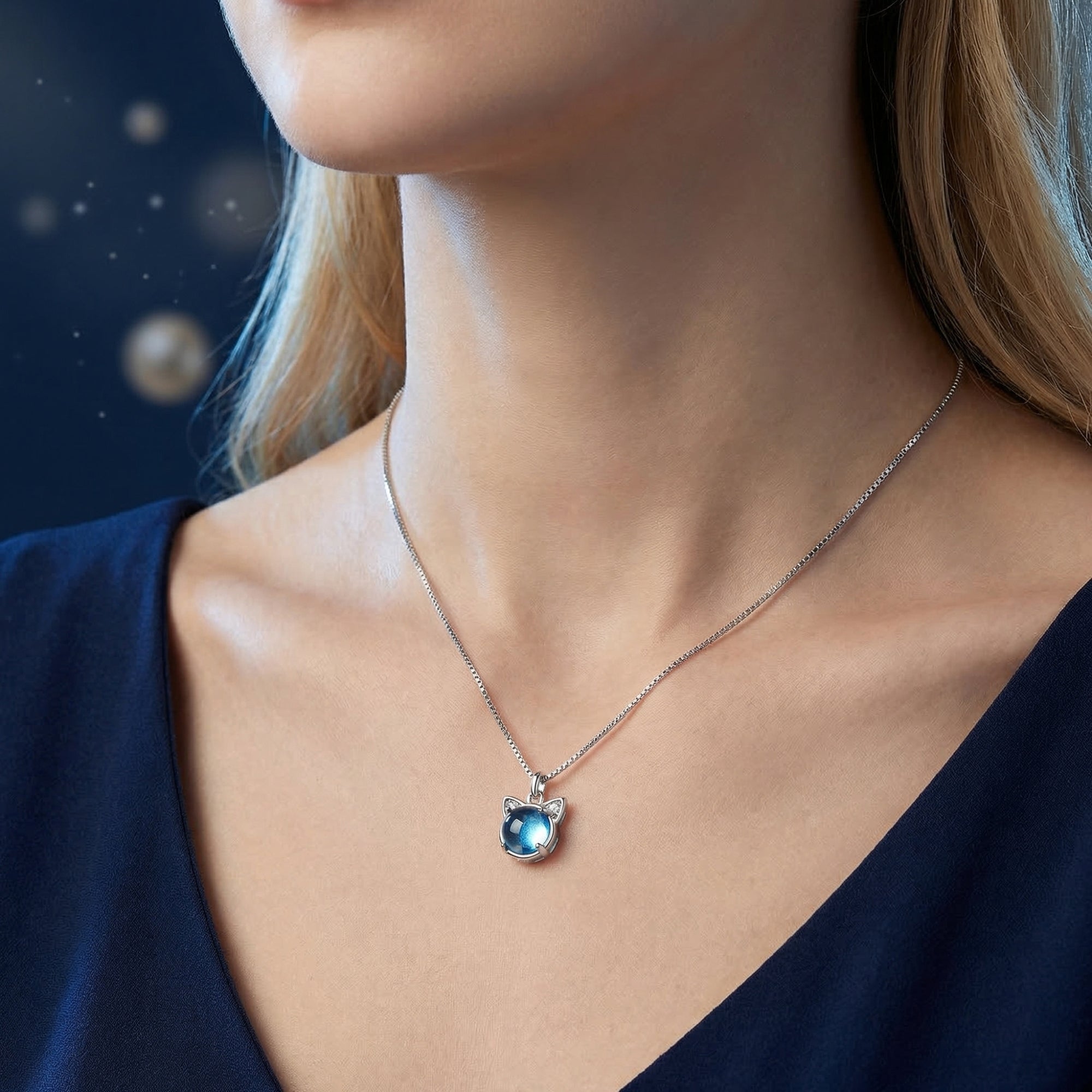 Model wearing the Cerulean Swiss Blue topaz cat pendant necklace in white gold.