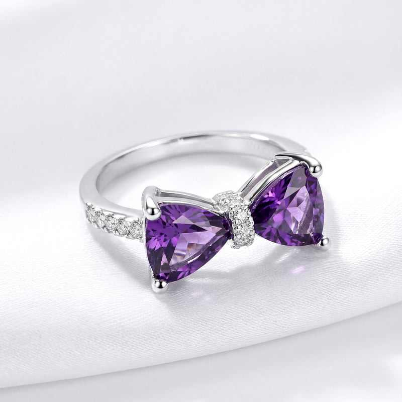 Front view of the sterling silver Violette bow ring with trillion-cut purple simulated amethysts.