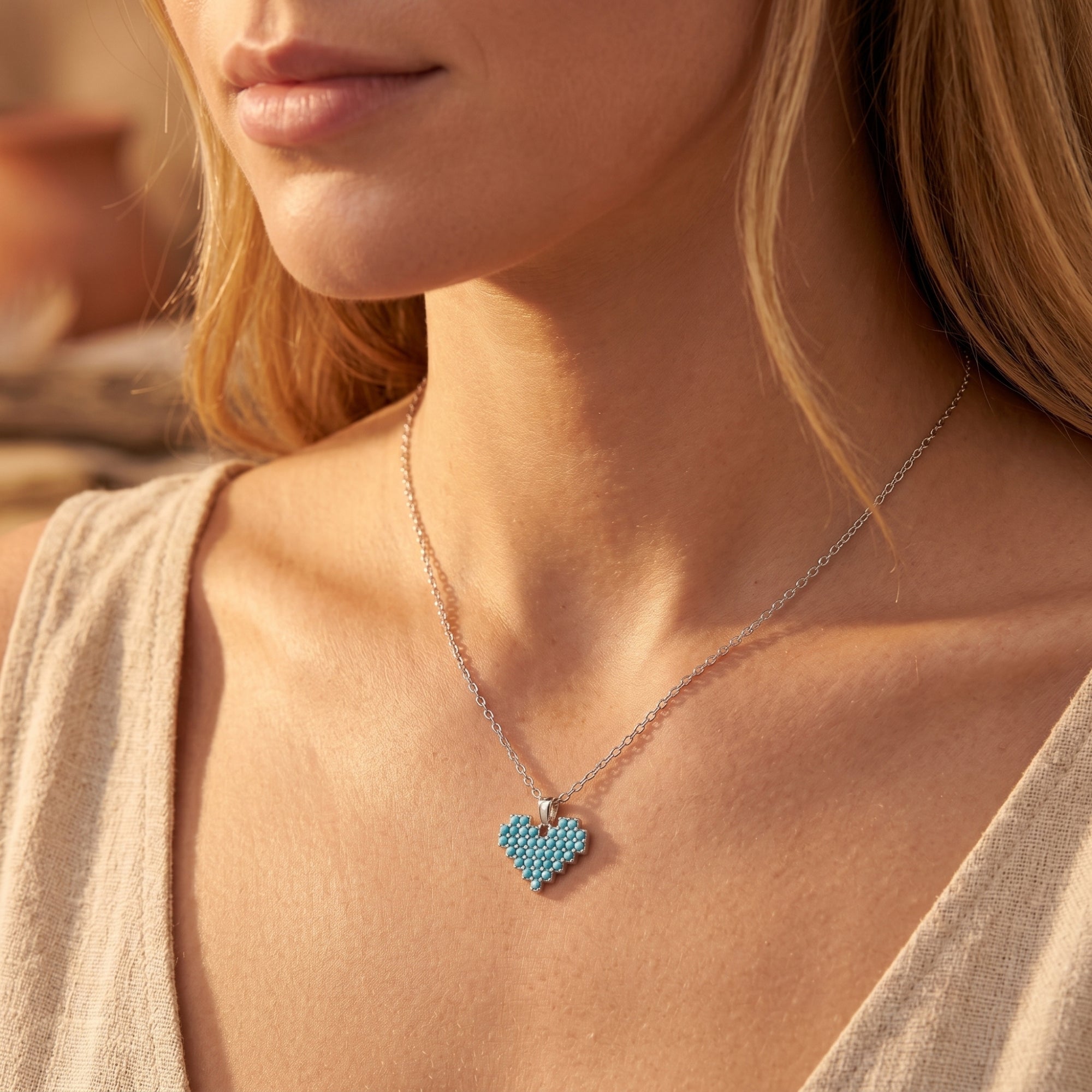 Woman wearing the silver Sedona Heart Turquoise Necklace with a Southwestern-inspired beaded heart pendant.