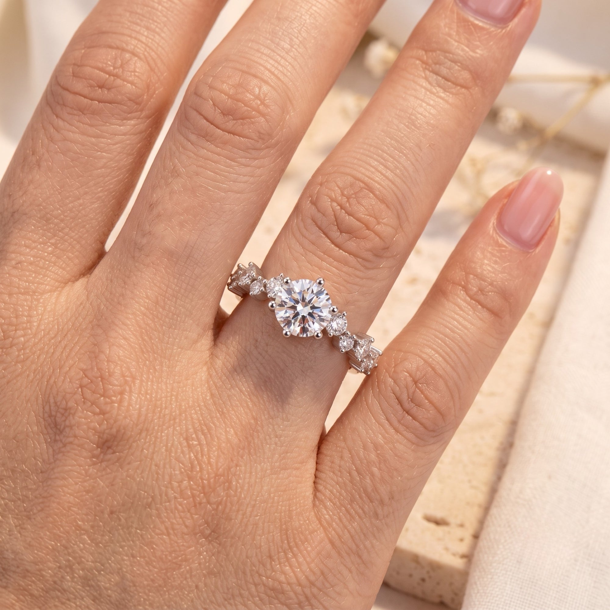 Silver Aura tiara ring with round brilliant cut stone worn on finger.