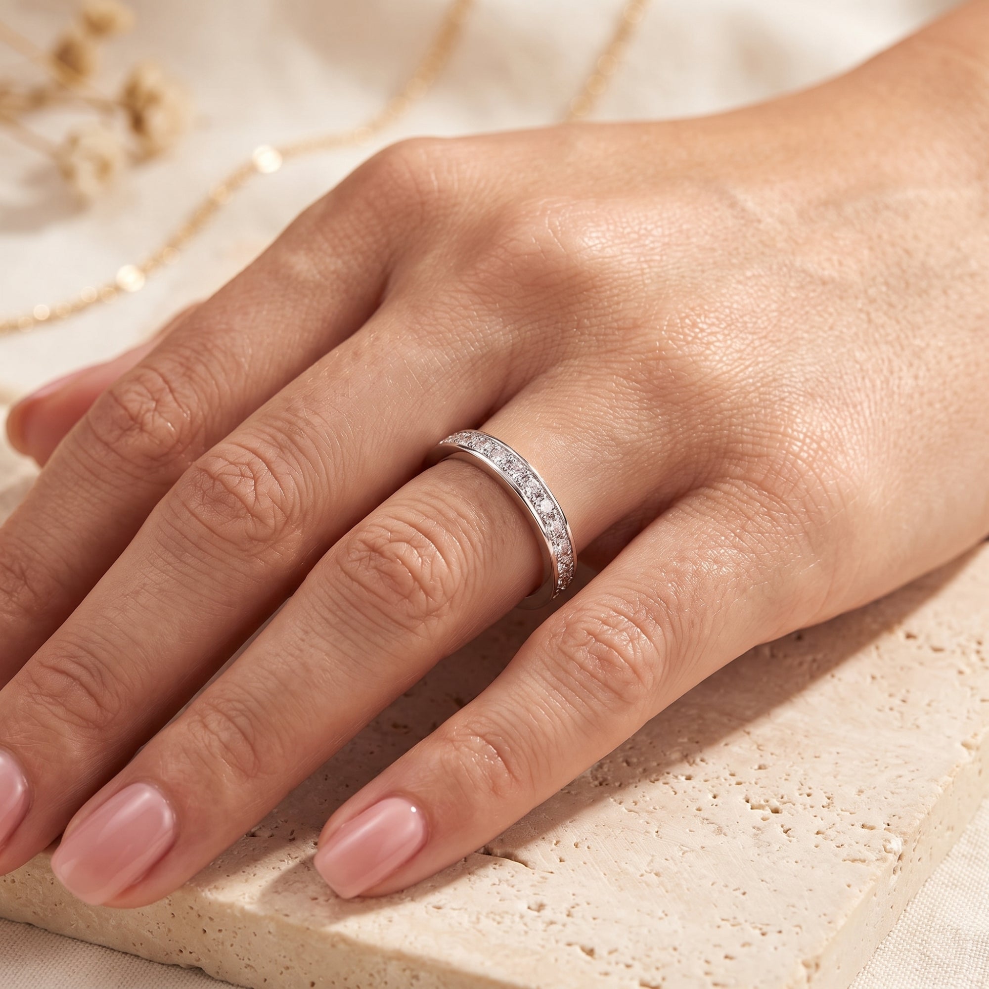 Sterling silver cubic zirconia eternity ring worn on a ring finger.