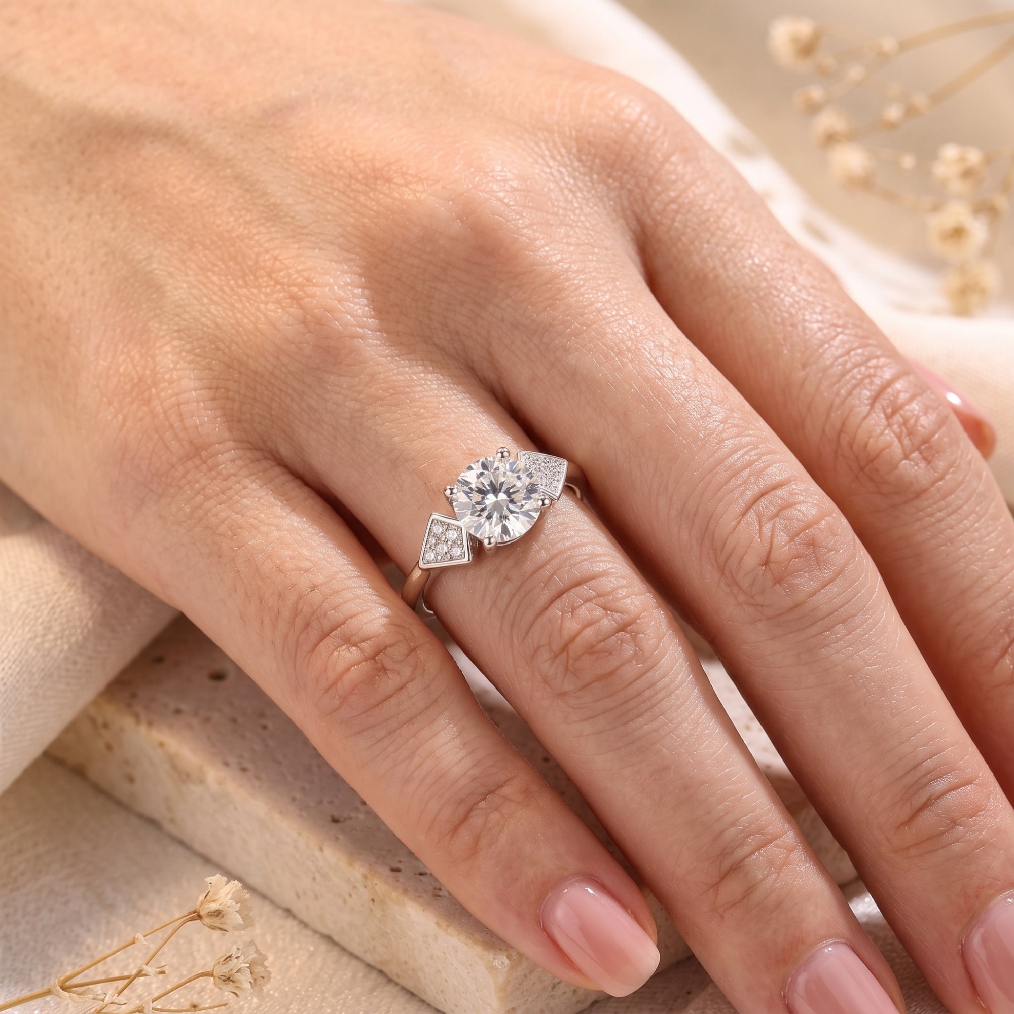 S925 sterling silver geometric ring with round brilliant stone worn on hand.