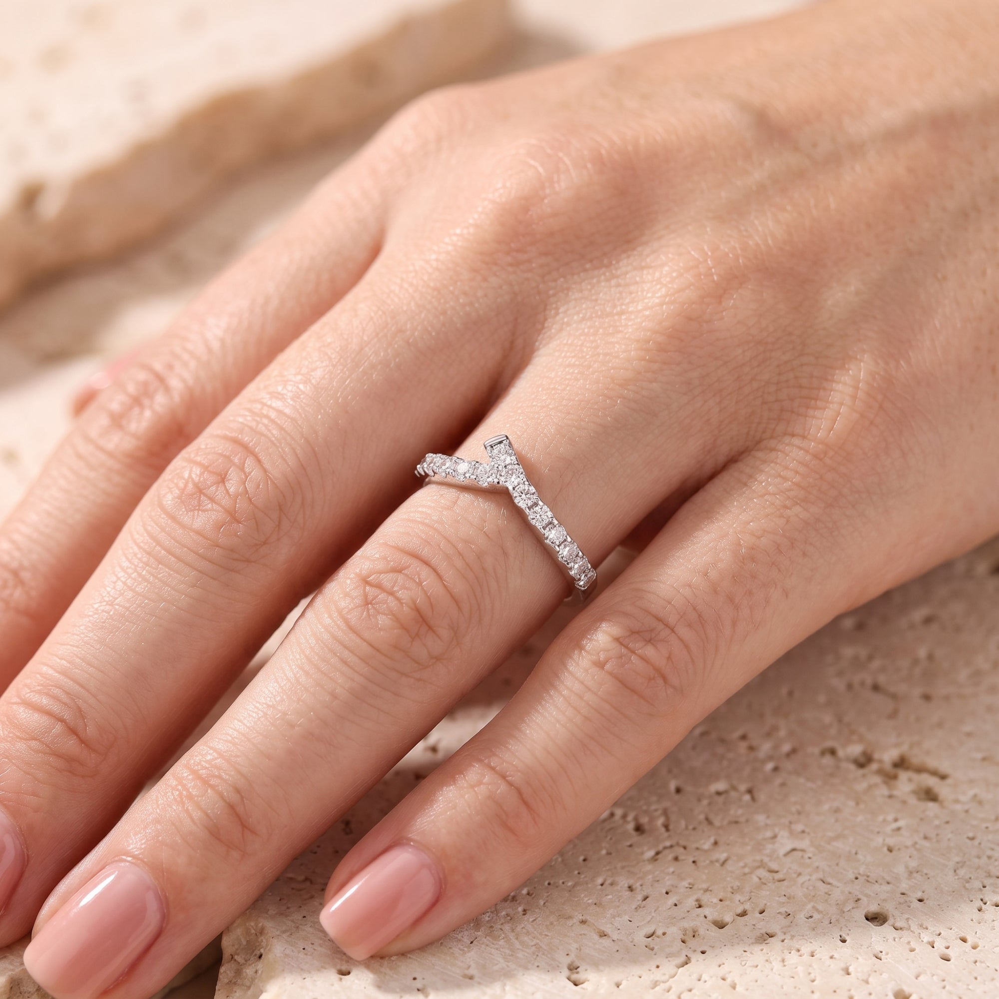 Top view of S925 silver asymmetric chevron ring with pave cubic zirconia on hand.