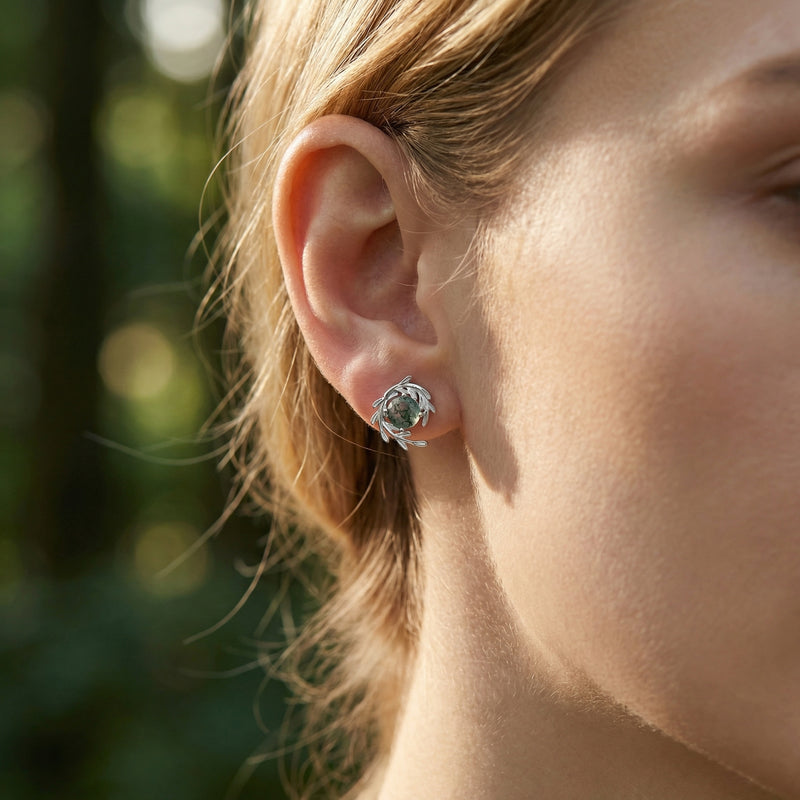 Model wearing a silver vine wrap stud earring with a natural green moss agate stone.