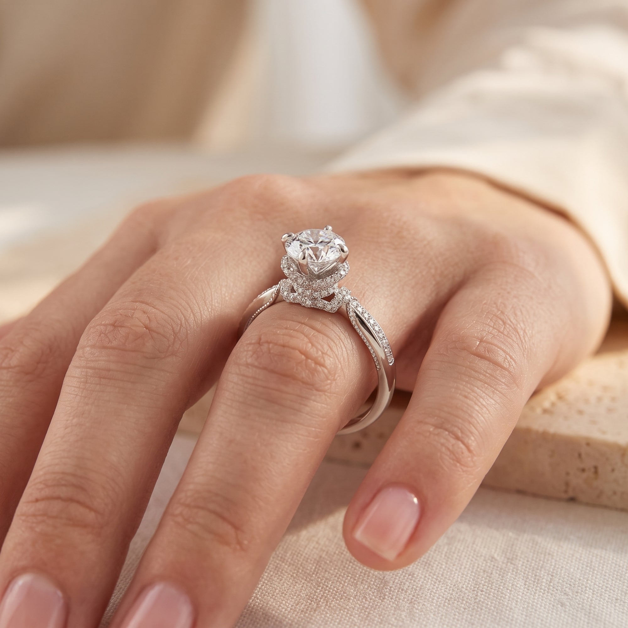 Vintage silver solitaire ring with round brilliant stone shown on a hand from a side view.