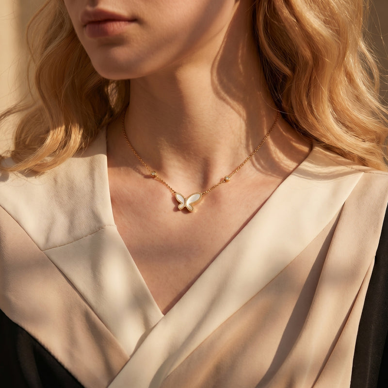 Vanessa gold butterfly necklace with mother of pearl pendant worn by a model.