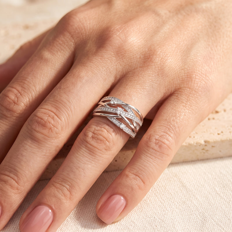 Sterling silver interwoven multi-row ring with cubic zirconia worn on a hand.