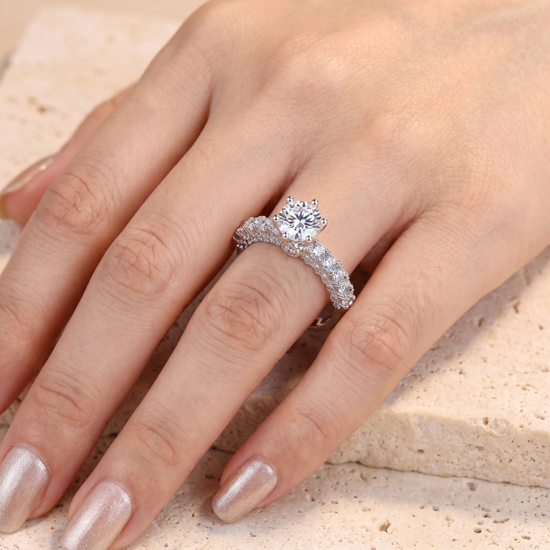 Round brilliant-cut cubic zirconia silver ring shown on a hand.