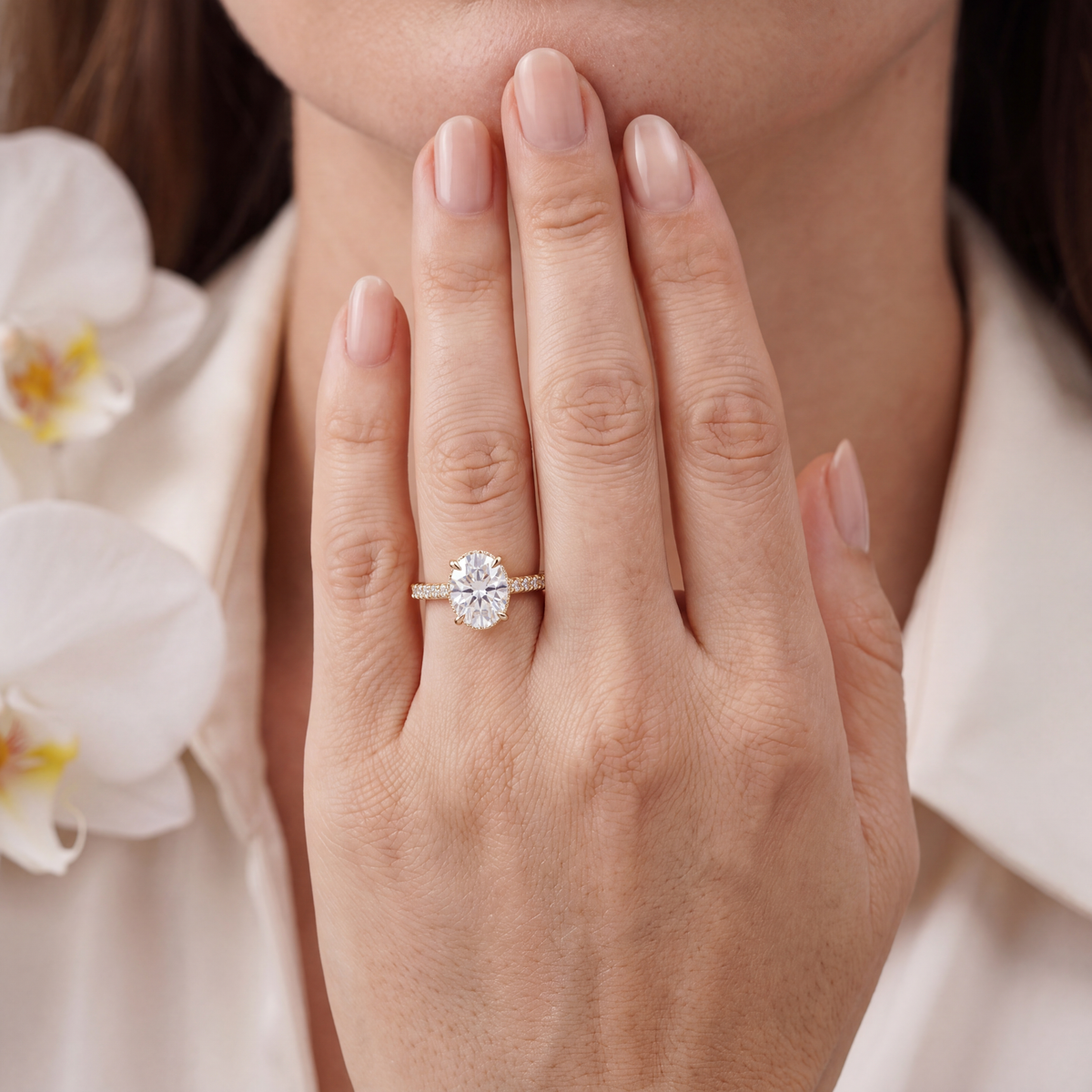 Model wearing the yellow gold oval moissanite engagement ring on her finger.
