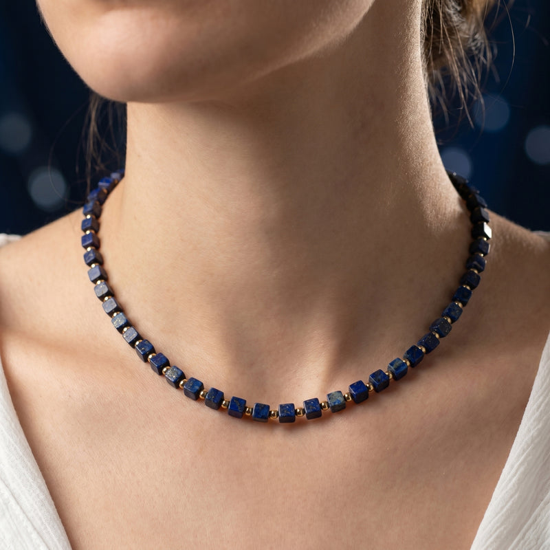 Model wearing the Sovereign Square natural lapis lazuli beaded necklace with gold-plated stainless steel.