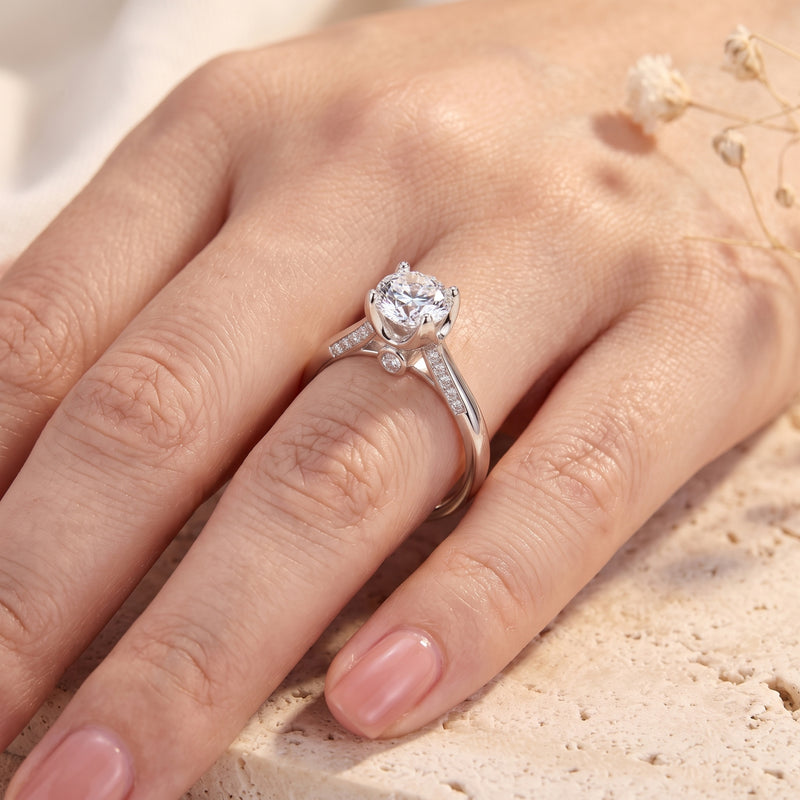 Sterling silver round CZ promise ring worn on hand.