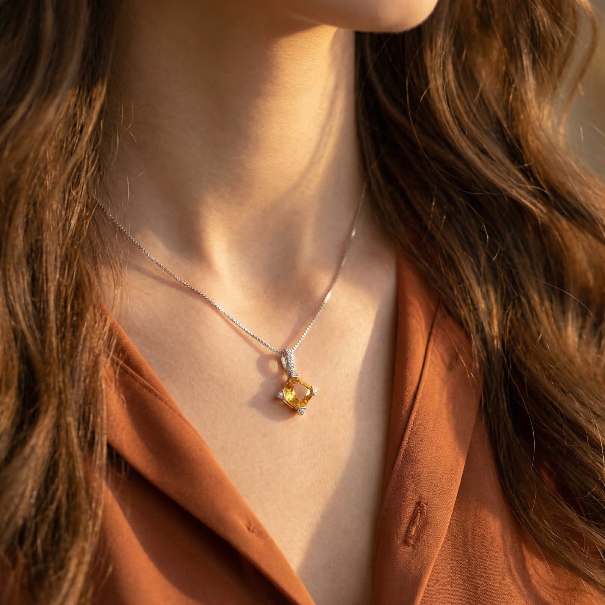 Model wearing the Aurestia natural citrine necklace in silver, highlighting the square-cut gemstone's honeyed warmth.