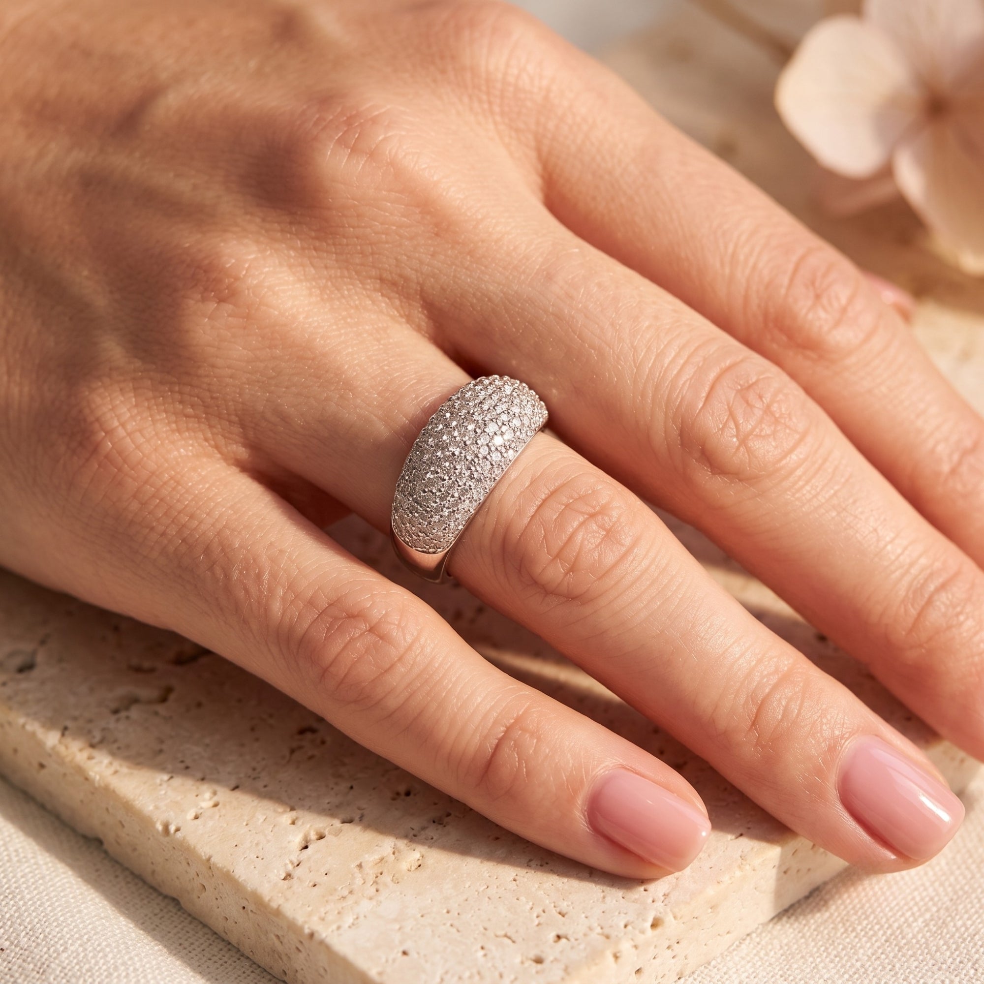 Sterling silver pave dome ring worn on a hand, showing shimmering CZ stones.