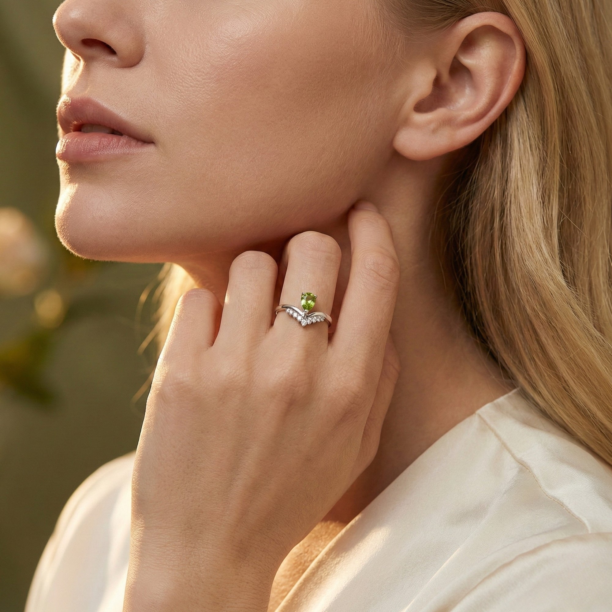 Model wearing the natural pear cut peridot sterling silver ring, showcasing the elegant V-shaped design.