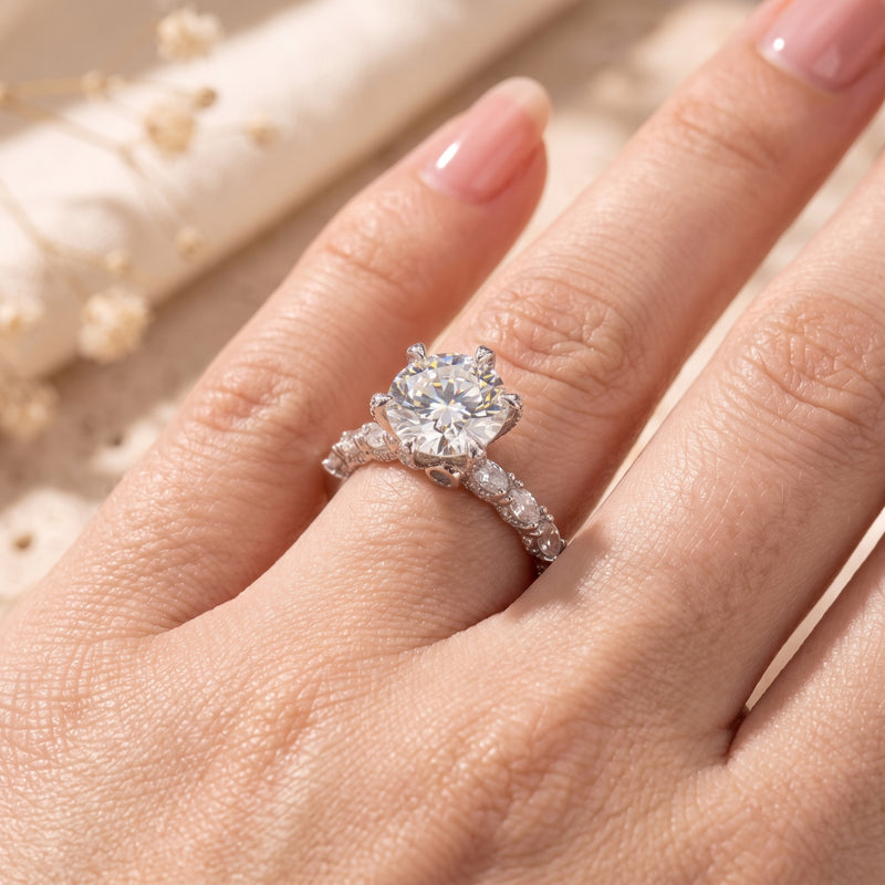 Stella six-prong silver promise ring with a round cut solitaire stone worn on a finger.