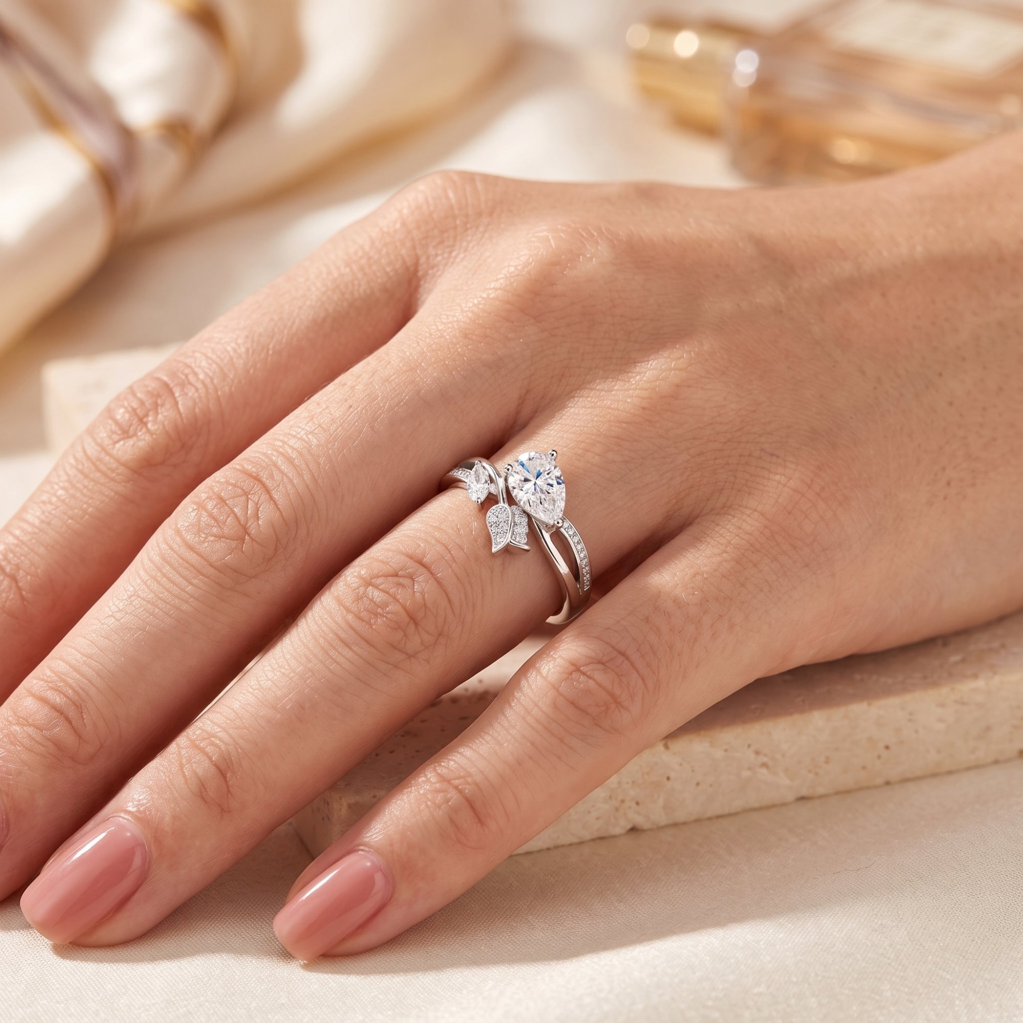 Pear-cut simulated diamond willow leaf ring in S925 sterling silver worn on a hand.
