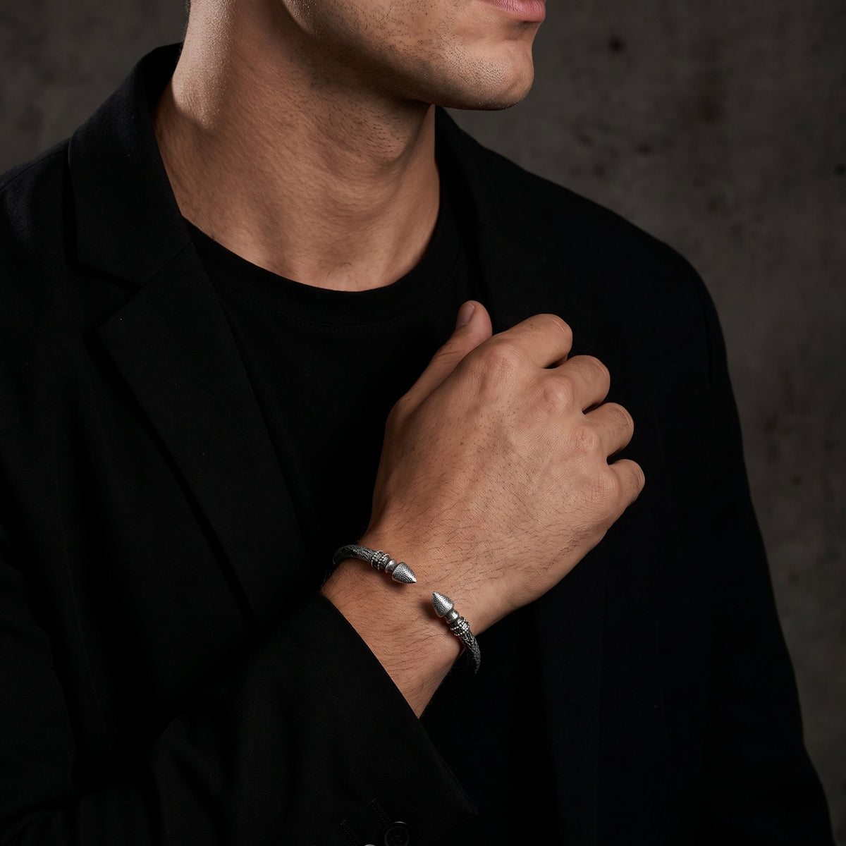 Model wearing the silver finial cuff bracelet on his wrist with a black blazer and T-shirt.