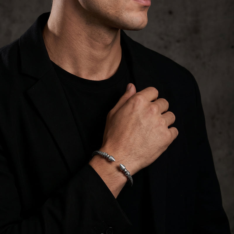 Model wearing the silver finial cuff bracelet on his wrist with a black blazer and T-shirt.
