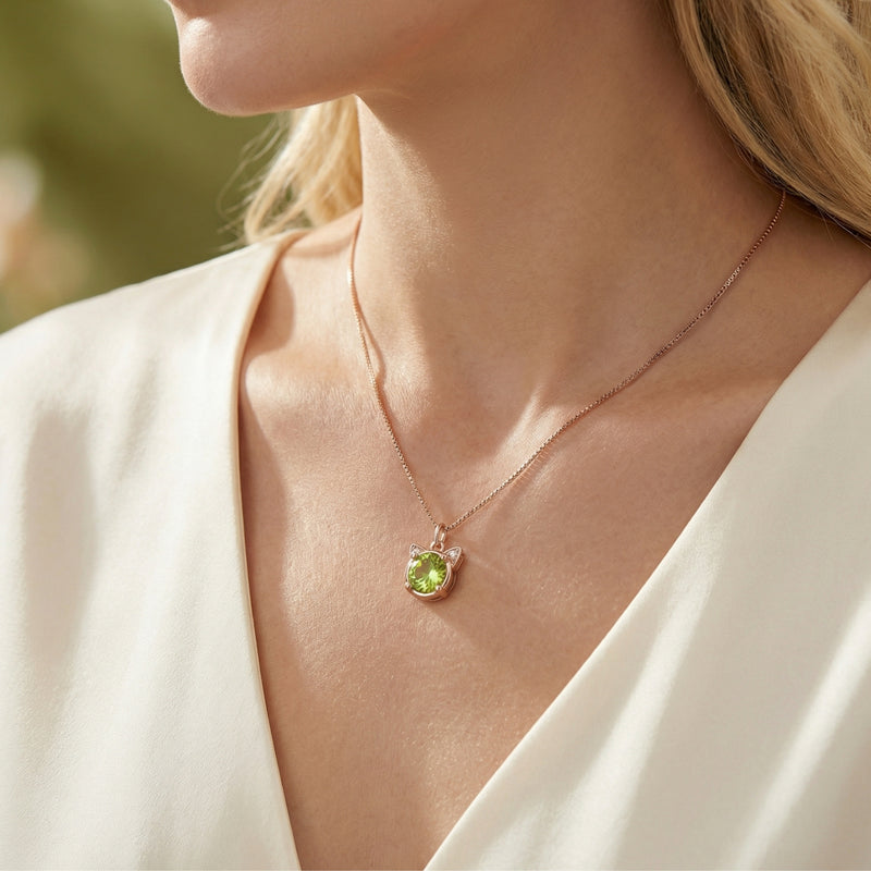 Woman wearing the Nerida round peridot cat pendant necklace in 18K rose gold vermeil.