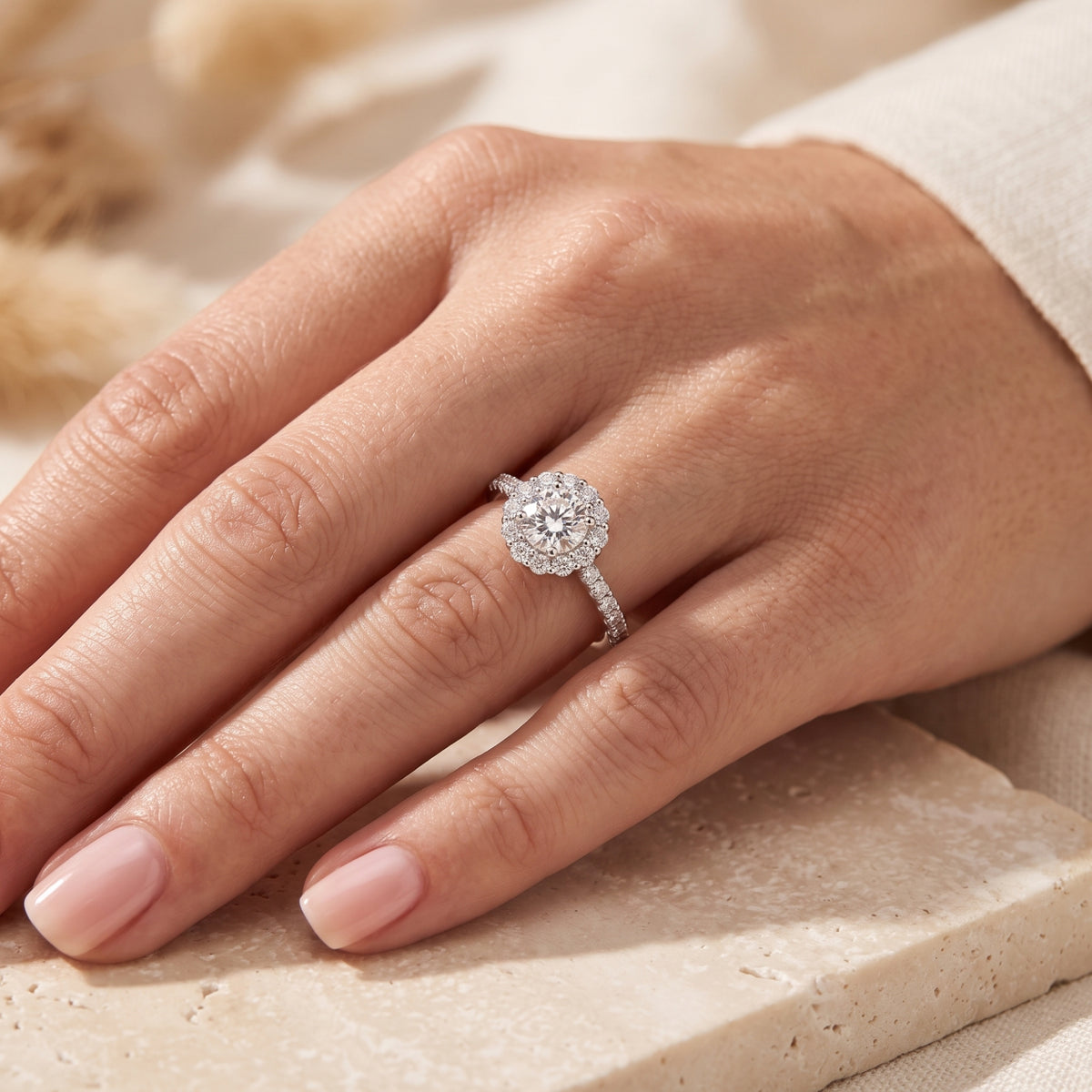 Close-up of a woman's hand wearing the S925 silver floral halo promise ring with a round-cut center stone.