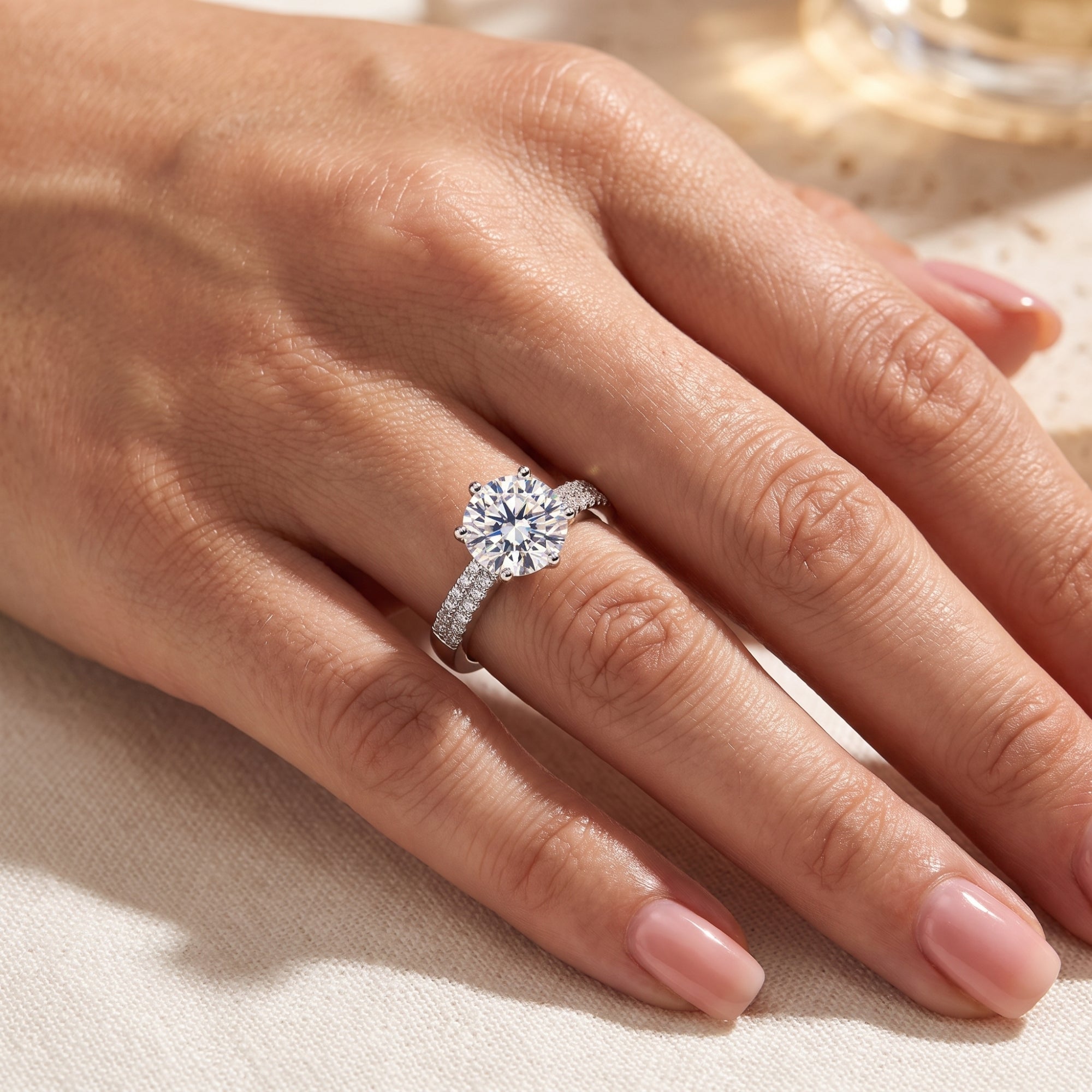 Sterling silver round-cut simulated diamond ring worn on a woman's hand.