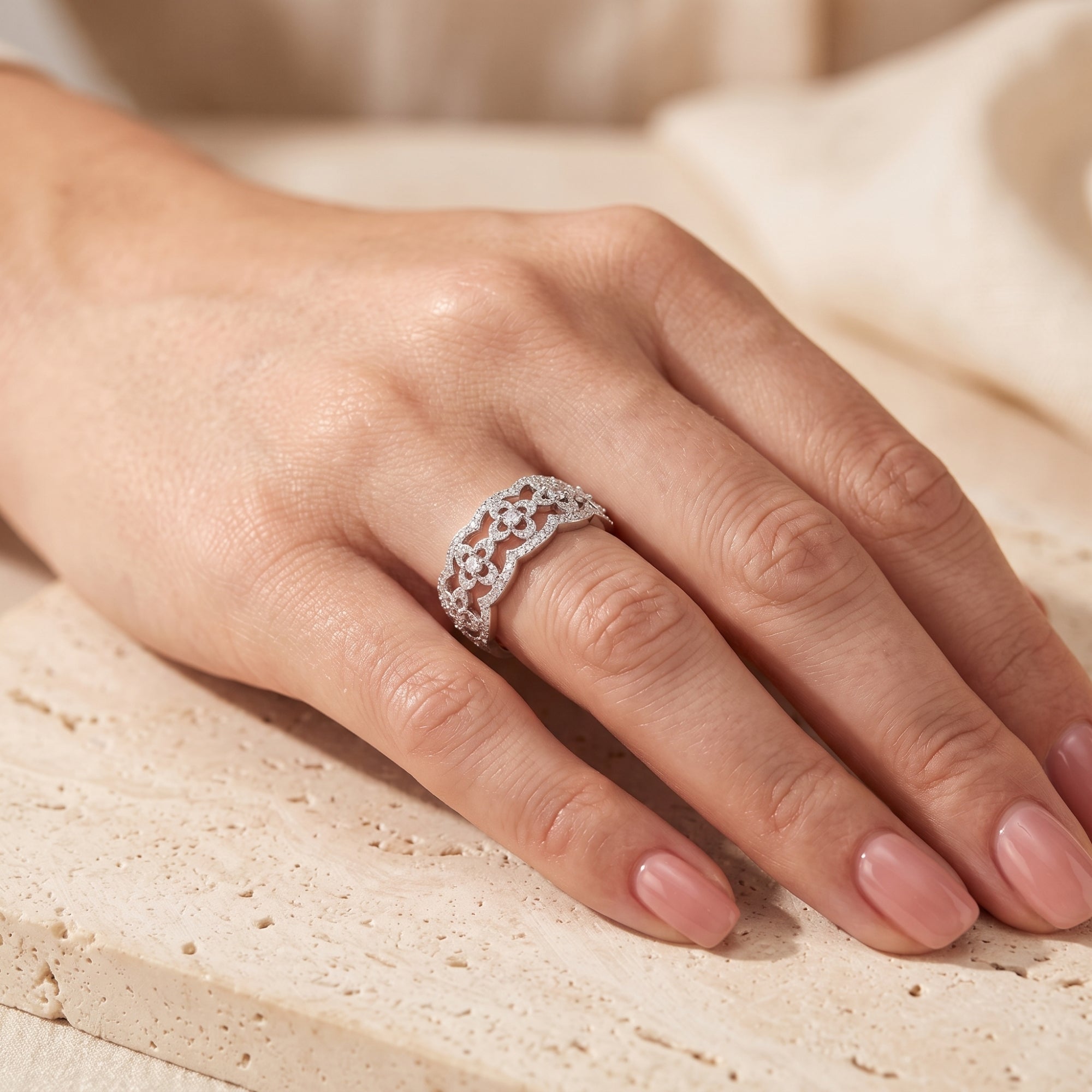 S925 sterling silver clover filigree promise ring with simulated diamonds worn on a woman's hand.