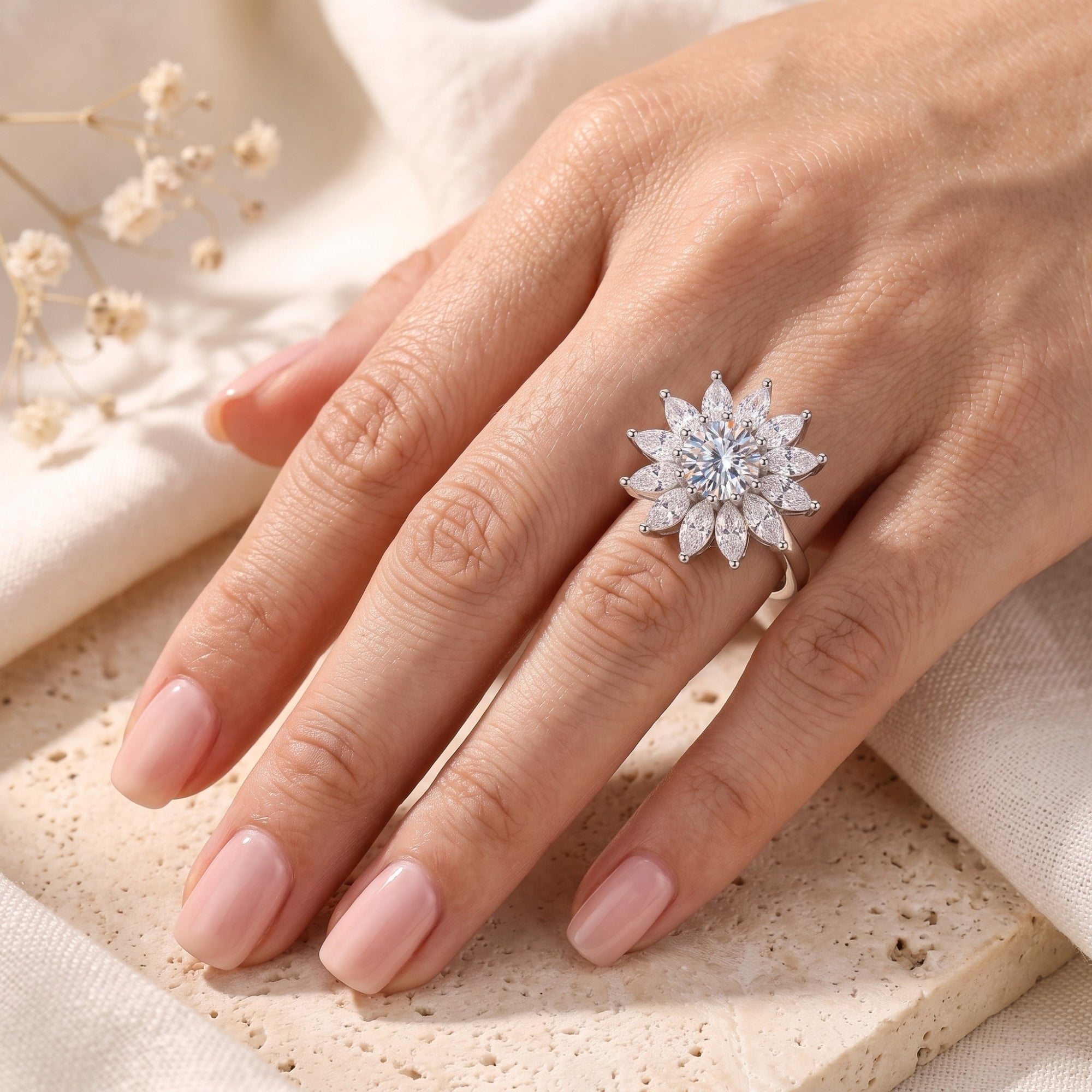 Women's S925 sterling silver sunburst ring with brilliant-cut stones worn on a hand.