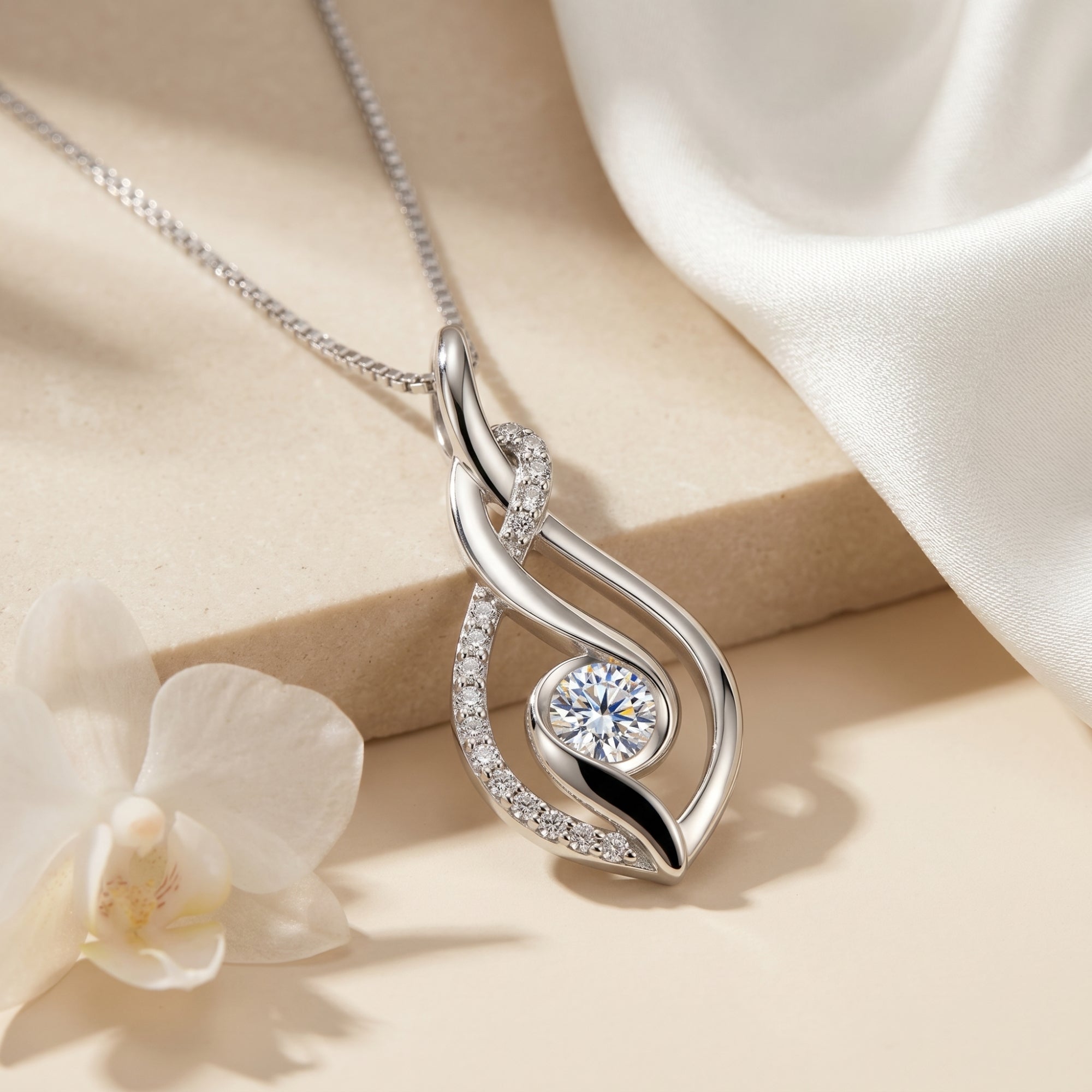 Sterling silver moissanite pendant with round-cut stone in a macro detail shot.