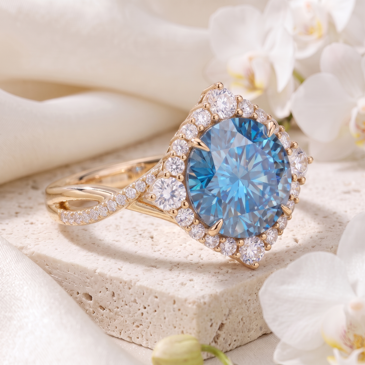 Angled view of a round blue moissanite halo ring in yellow gold resting on a stone display.