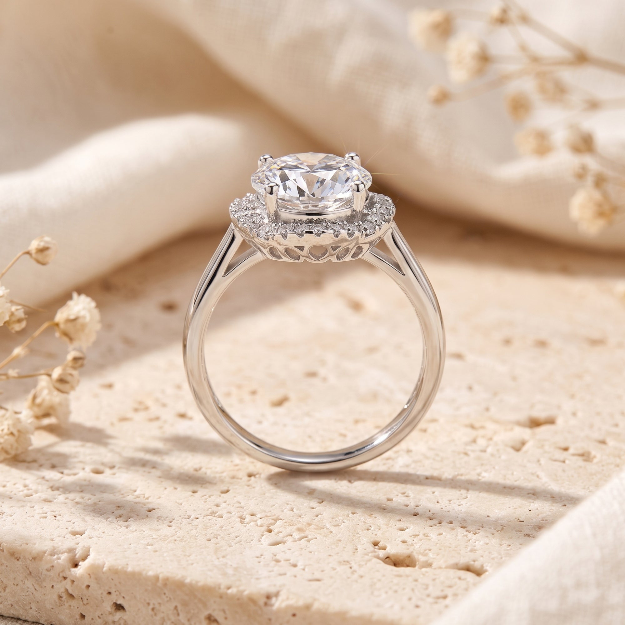 Side profile of silver halo ring showing heart-shaped filigree and simulated diamond.