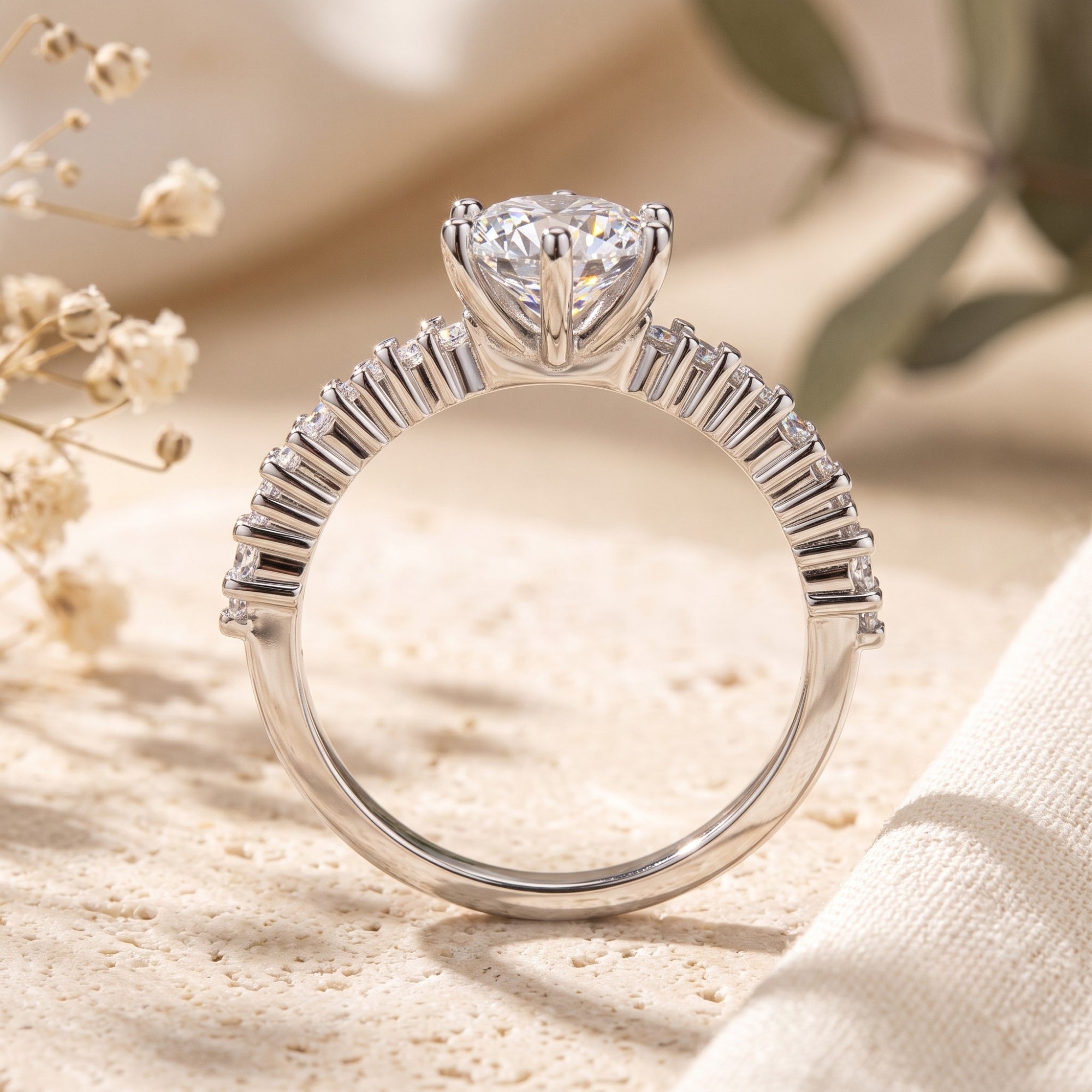 Side view of silver tiara ring showing round cut stone and cluster setting.