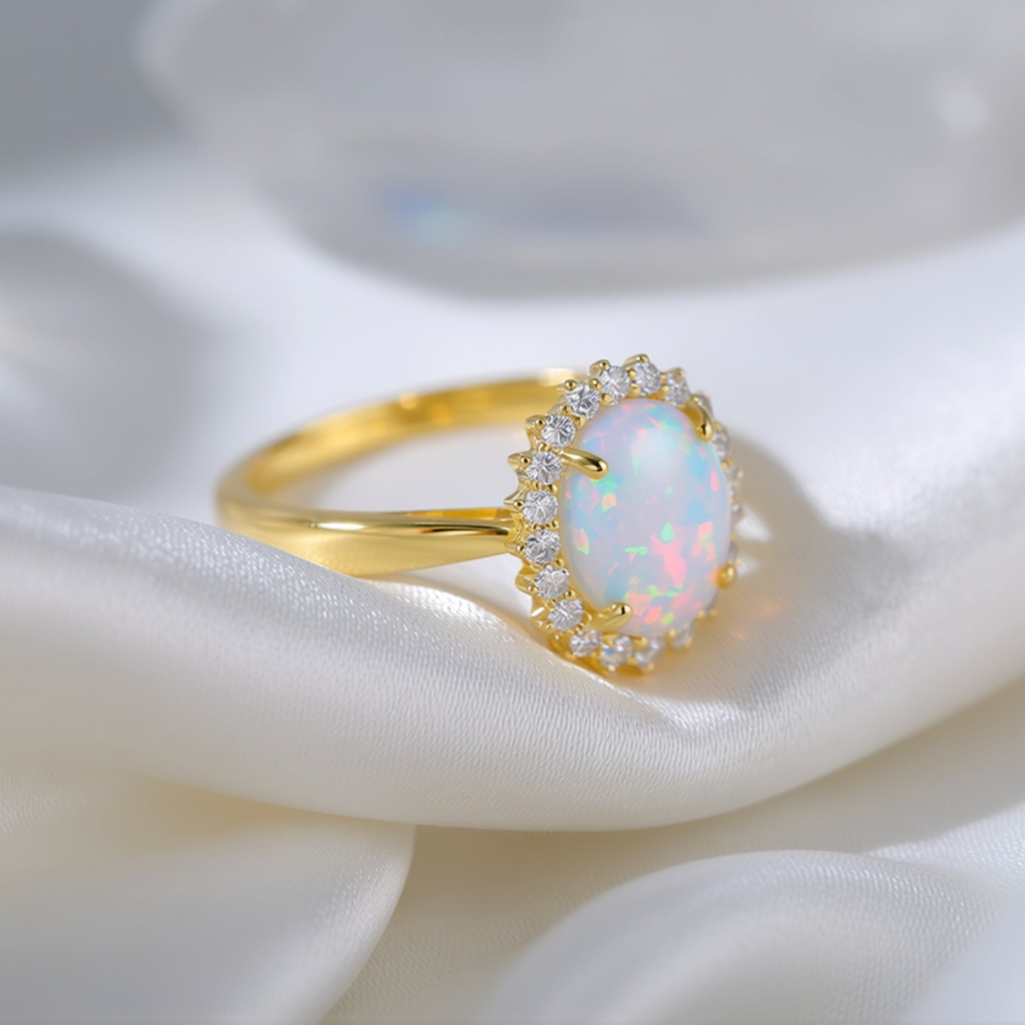 Angled close-up of the gold vermeil oval opal ring, highlighting the stone's iridescent play-of-color.