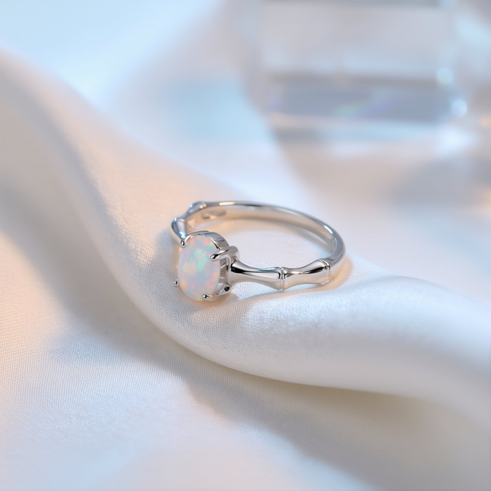 Side view of the Guinevere oval-cut opal ring in S925 sterling silver, showcasing the ornate crown setting.