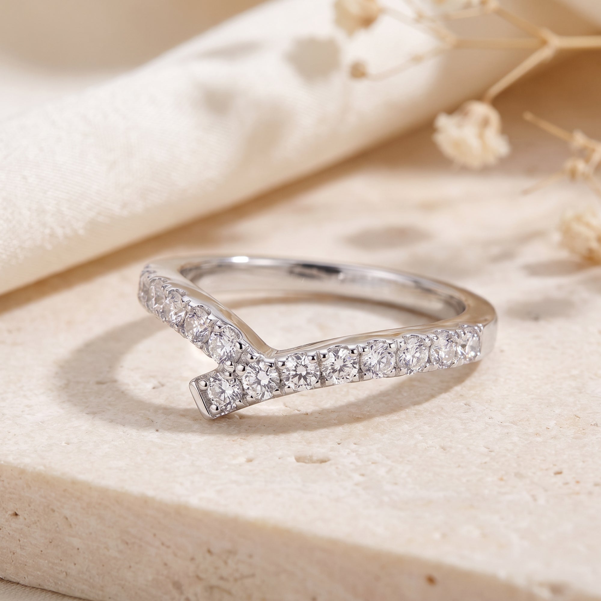 Macro view of S925 silver wishbone ring with pave cubic zirconia.