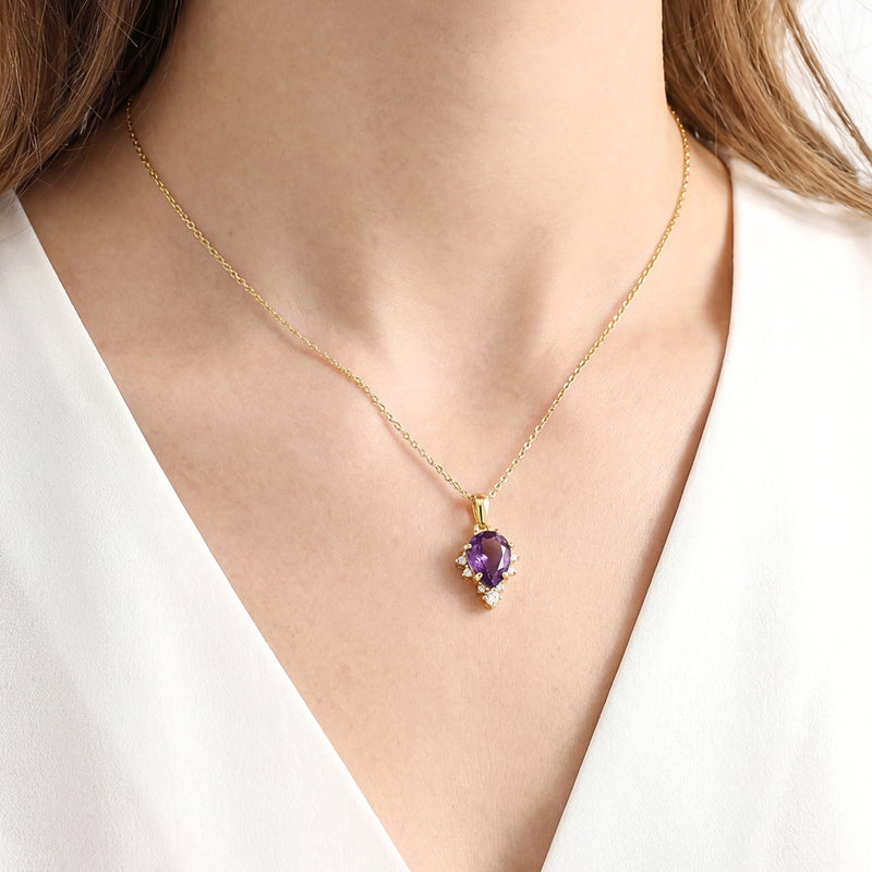 Woman wearing the Eudora Drop necklace with a pear cut simulated amethyst in 18K gold vermeil.