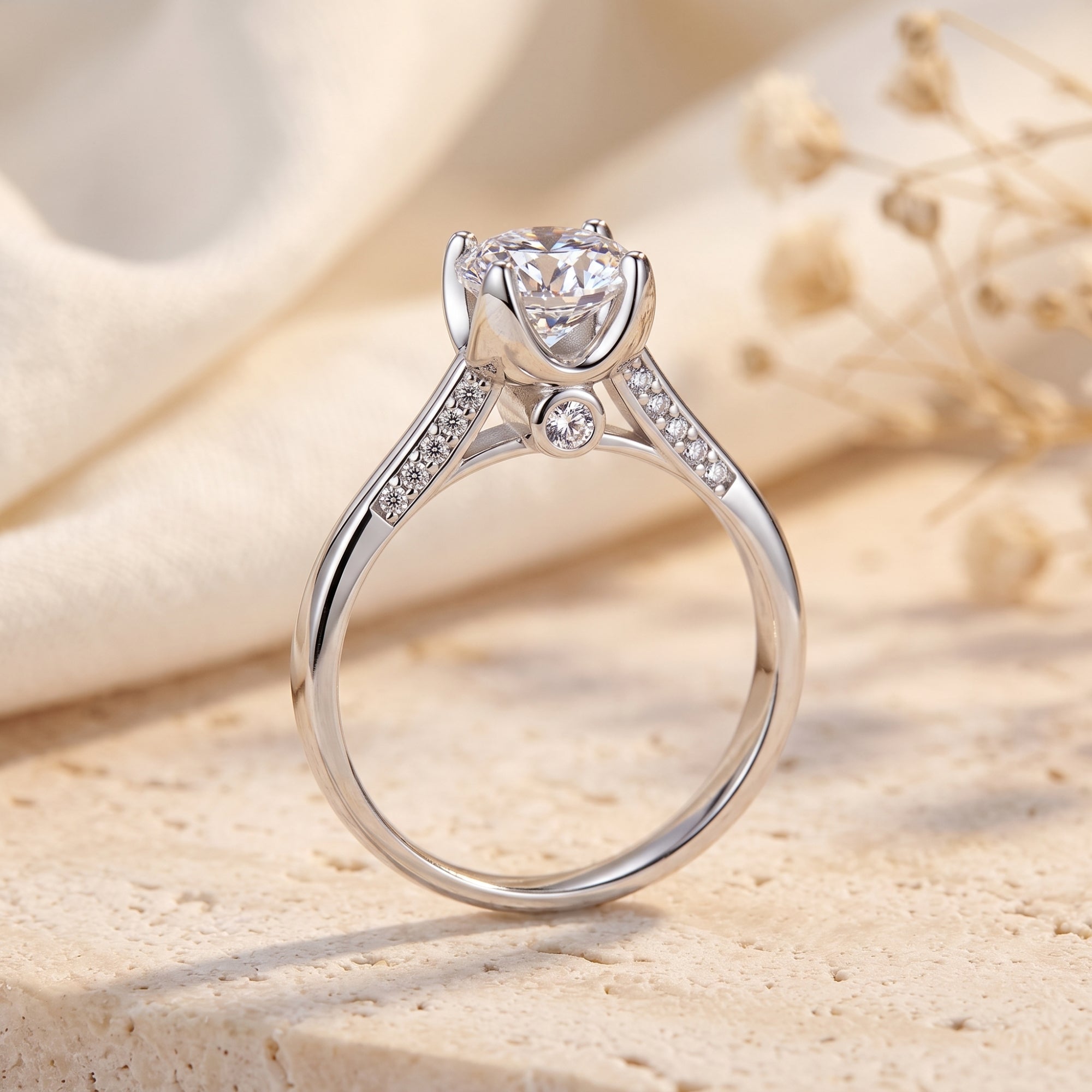 Macro view of crown setting and round CZ on silver solitaire ring.