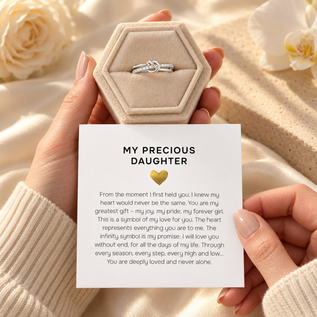 Silver knot ring in a standard cream jewelry gift box beside the My Precious Daughter card