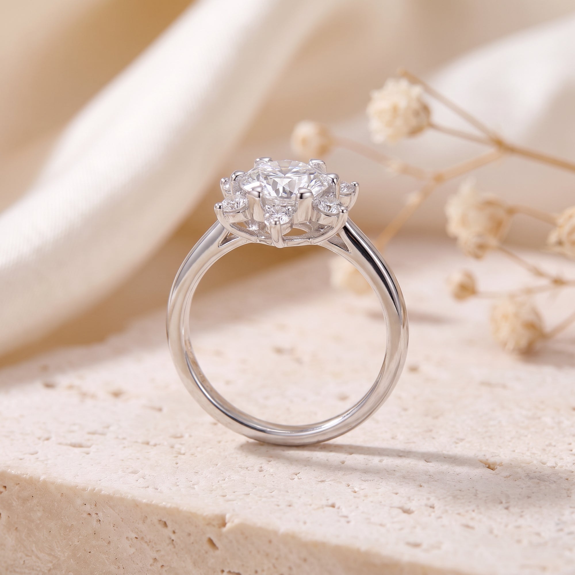 Side profile of a sterling silver snowflake ring showing the band and raised stone setting.