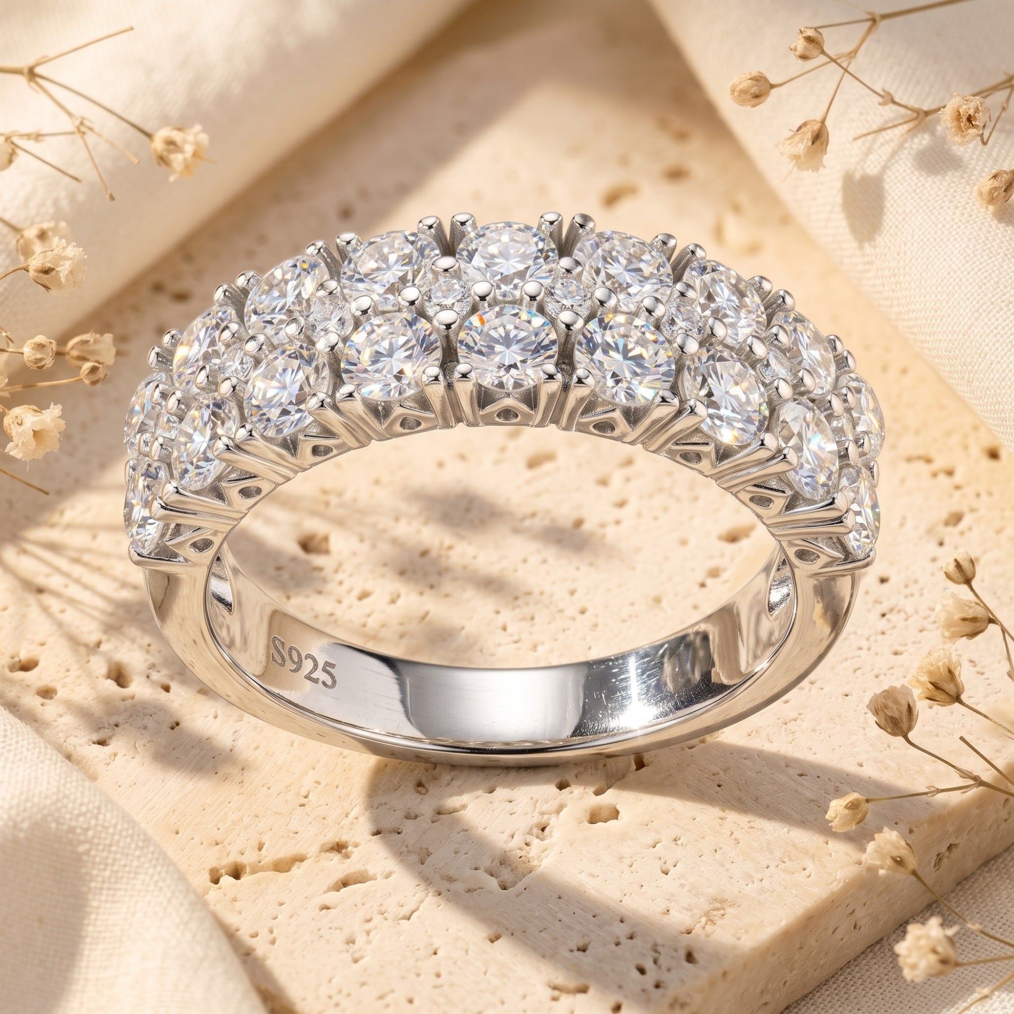Detail view of triple row sterling silver ring with round cubic zirconia and S925 engraving.