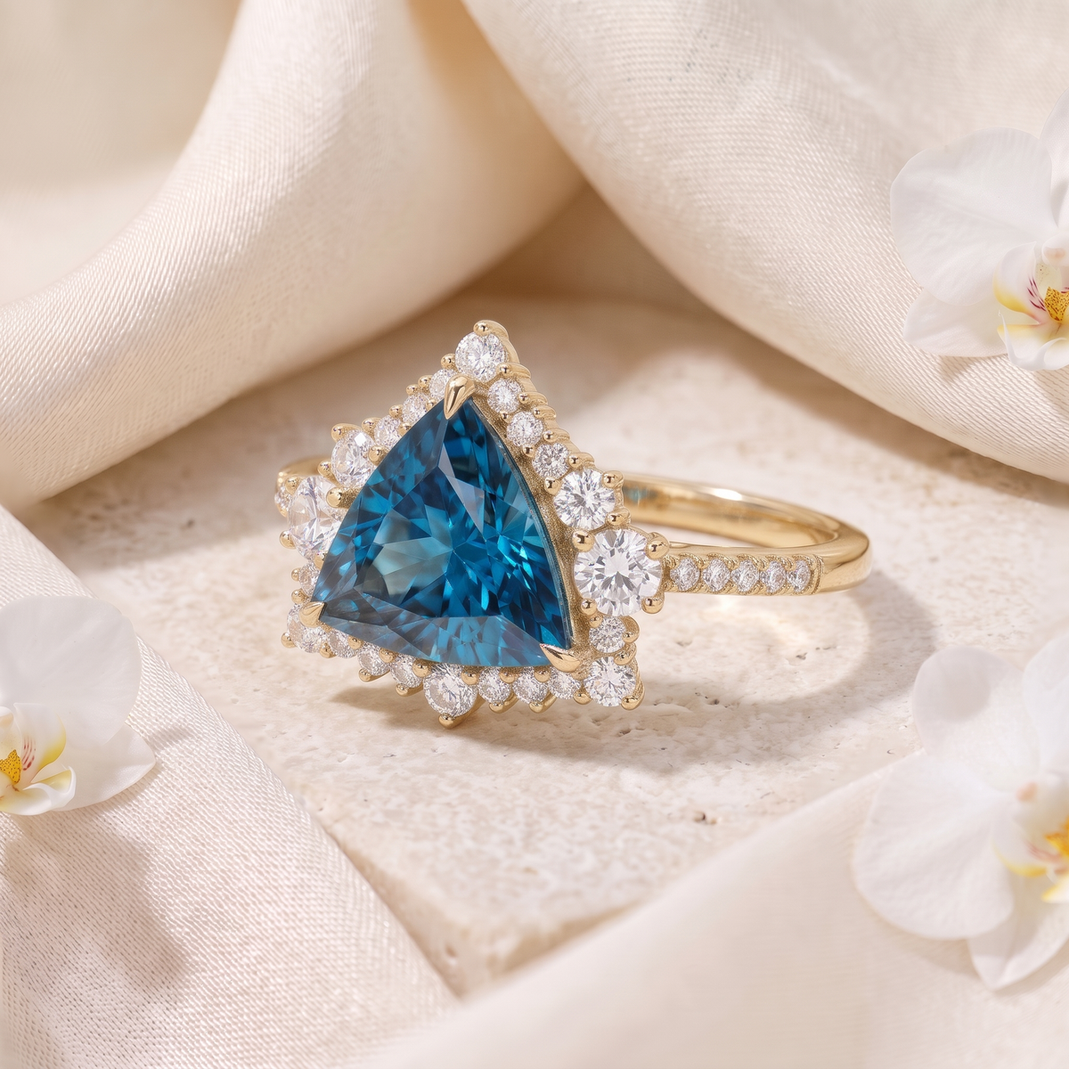 Perspective view of a trillion-cut blue moissanite halo engagement ring in yellow gold.
