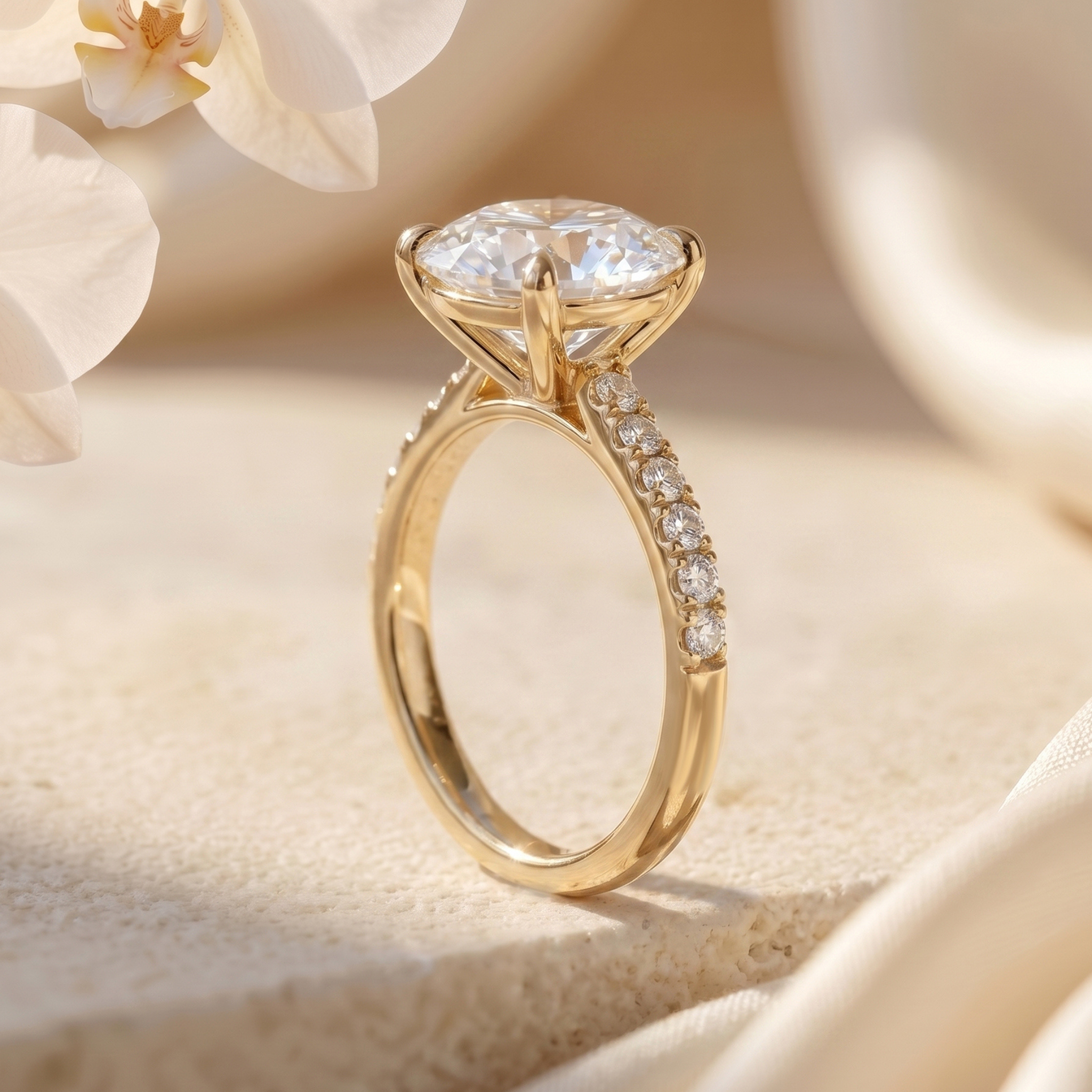 Profile view of a yellow gold round moissanite ring showing the intricate under-gallery and diamond-encrusted band.