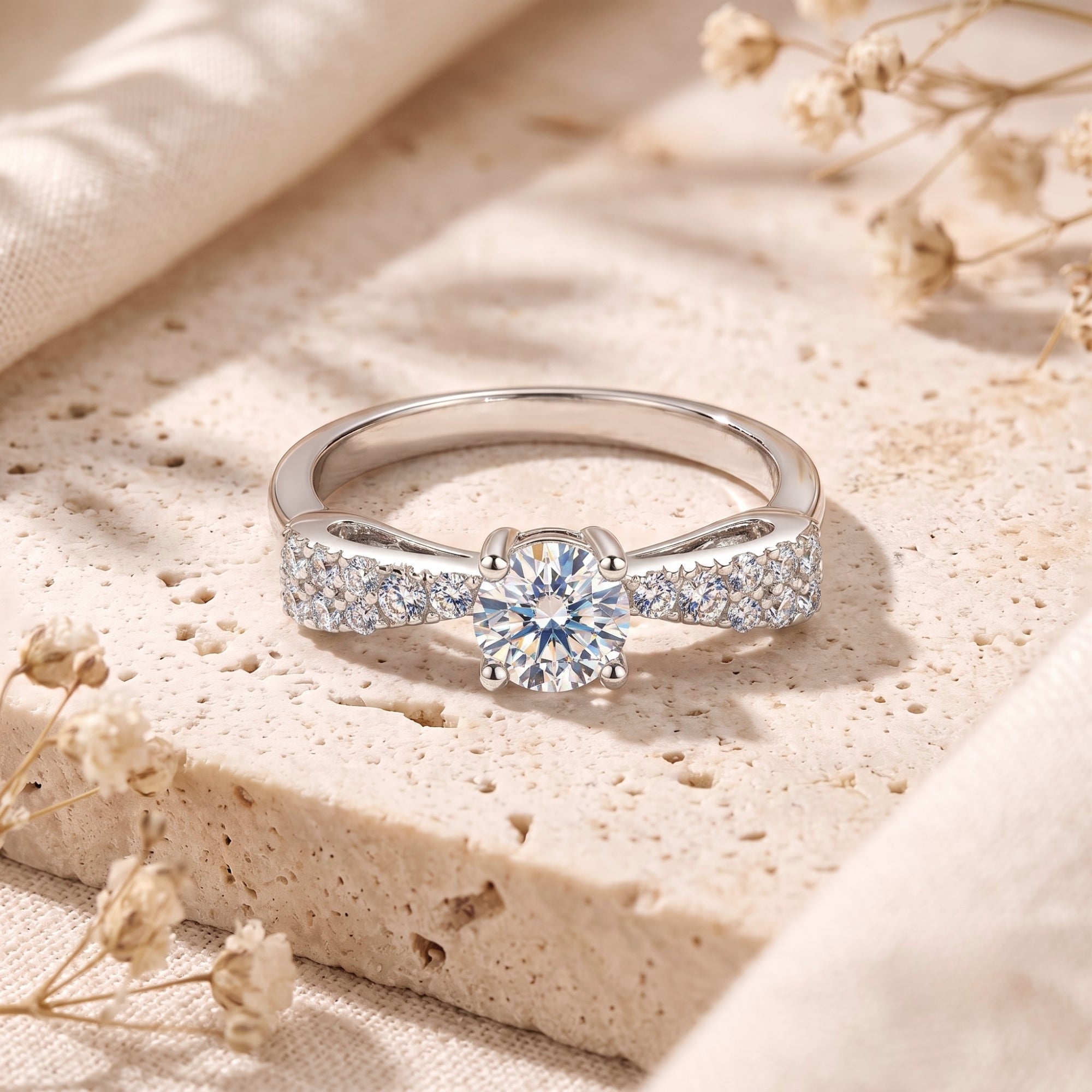 Close-up of a sterling silver bow ring featuring a round cubic zirconia and micro-set accents.