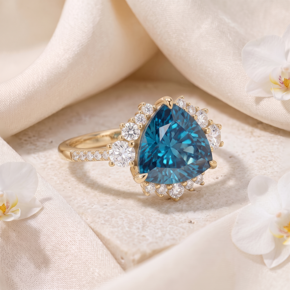 An angled view of a yellow gold engagement ring with a trillion-cut blue moissanite and diamond halo.